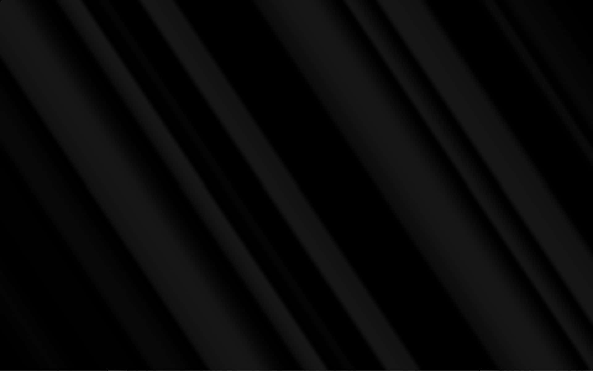 Plain Black Desktop 桌布 壁紙 — 對角黑色布料褶皺營造出極簡抽象紋理，帶有微妙的色調變化。