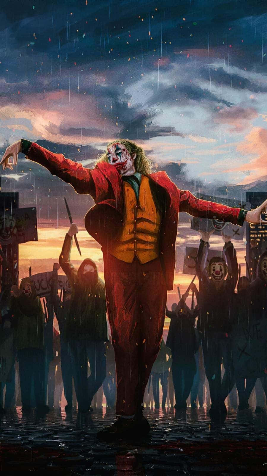 Arthur Fleck 桌布 壁紙 — 小丑在濕透的街道上張開雙臂站立，一群戴面具的追隨者在戲劇性的暮色天空下歡呼。