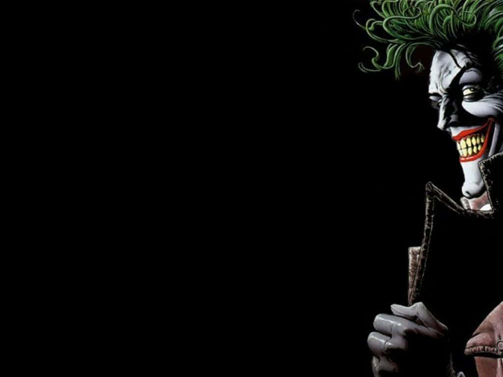 The Joker Comic 桌布 壁紙 — 小丑從黑暗中窺視，一頭狂野的綠髮，邪惡的笑容，襯托著黑色的虛空。