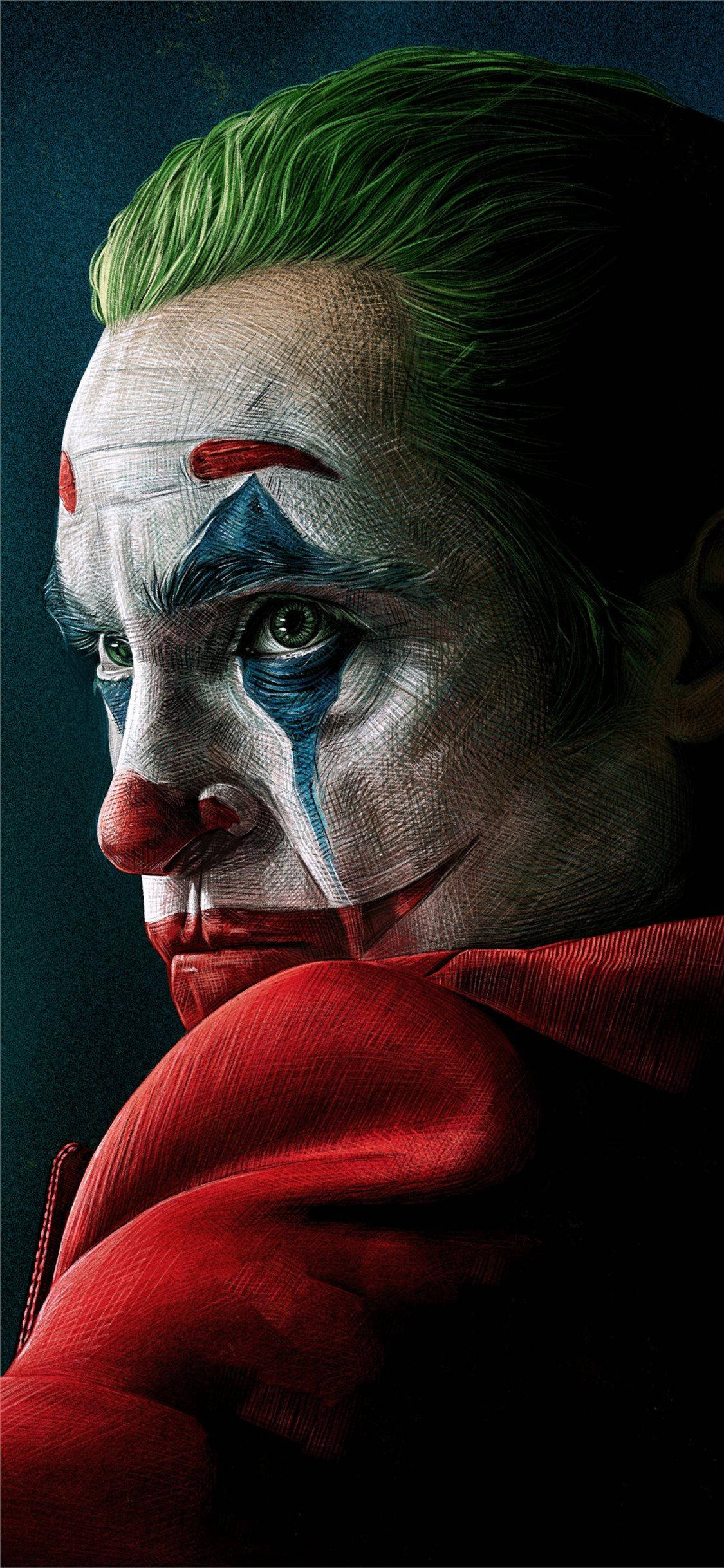 iPhone 11 Pro Max 桌布 壁紙 — 小丑的頭像特寫，綠色頭髮、白色臉龐、紅色嘴唇和藍色眼淚，背景為深色。