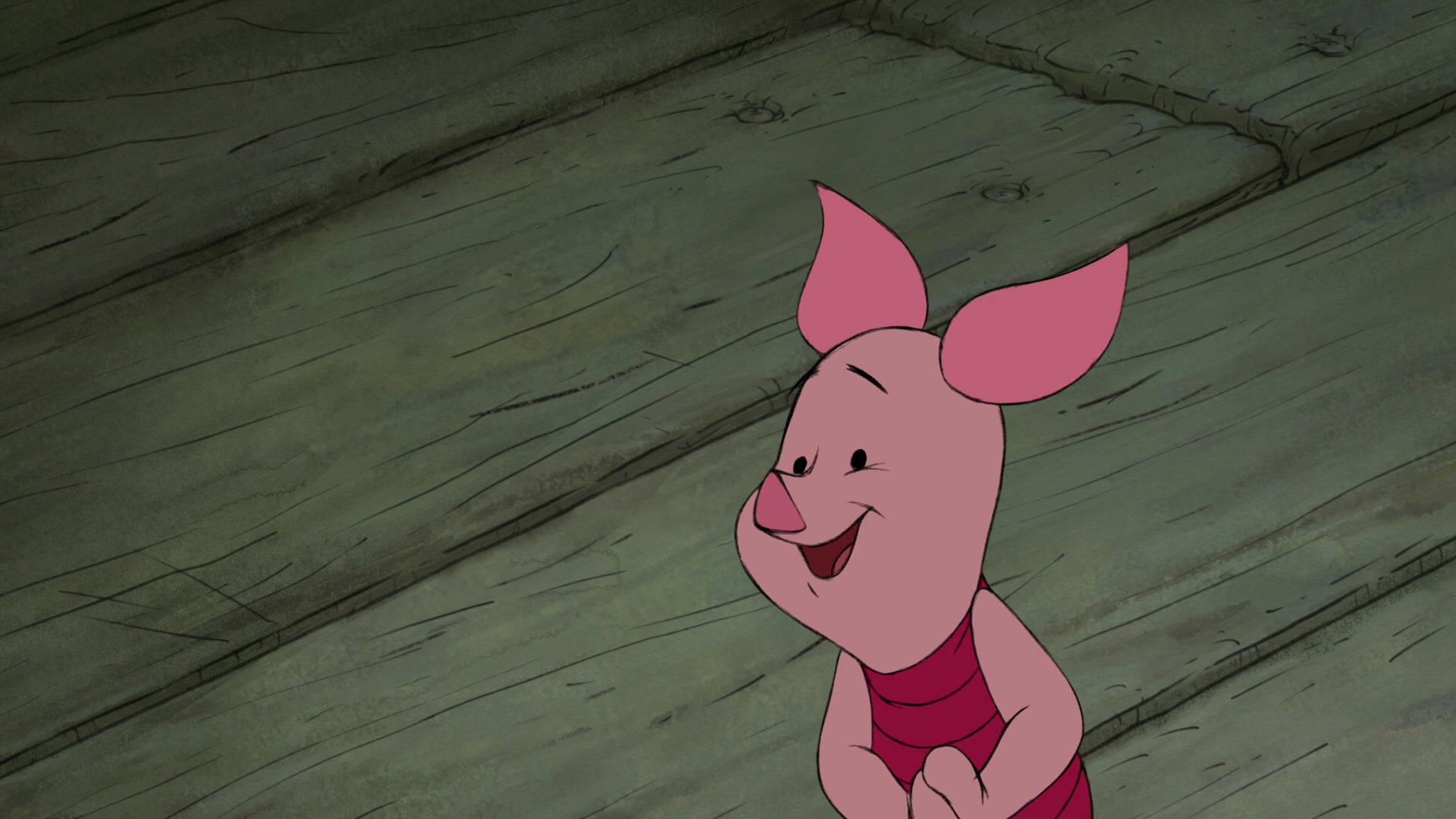 Piglet 桌布 壁紙 — 小熊維尼中的小豬皮傑在經典迪士尼動畫中，在風化的木地板上愉快地微笑。