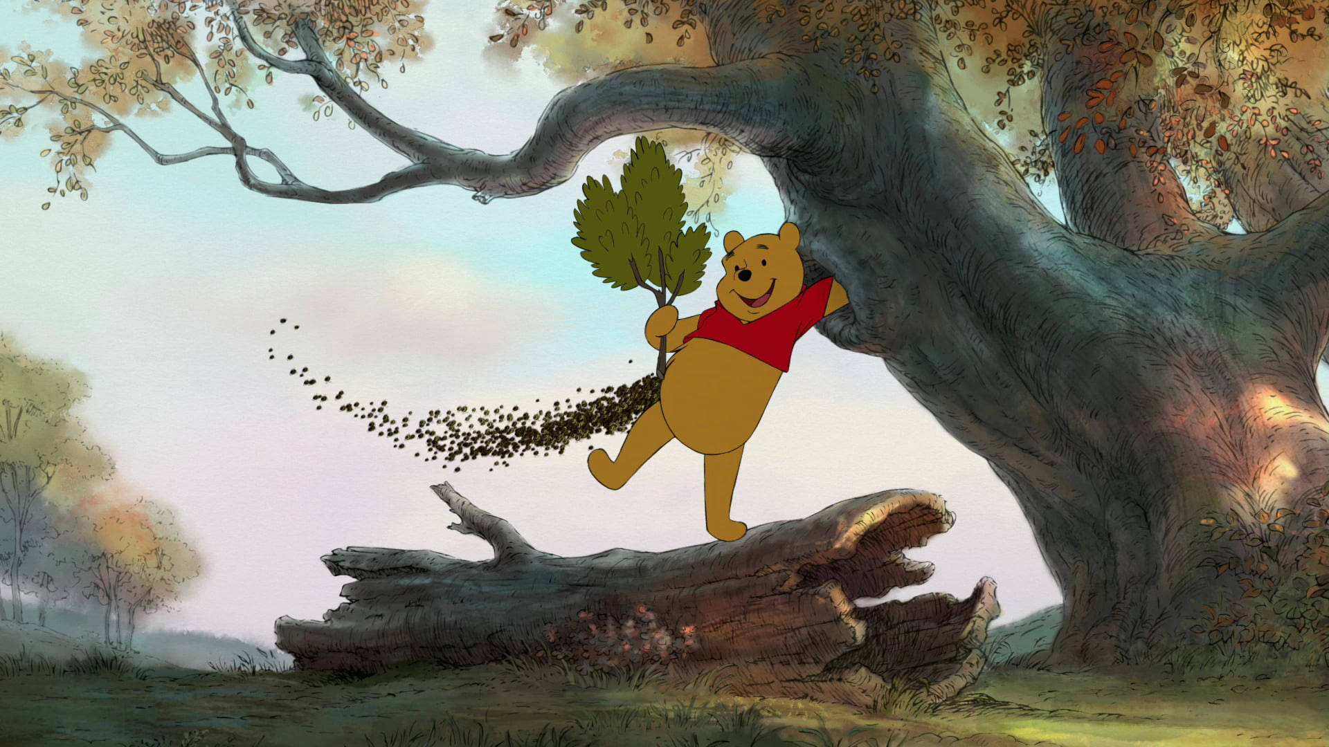 winnie the pooh 桌布 壁紙 — 小熊維尼穿著紅色襯衫，開心地從樹枝上盪下來，手持一根樹枝，身後有落葉飄落。