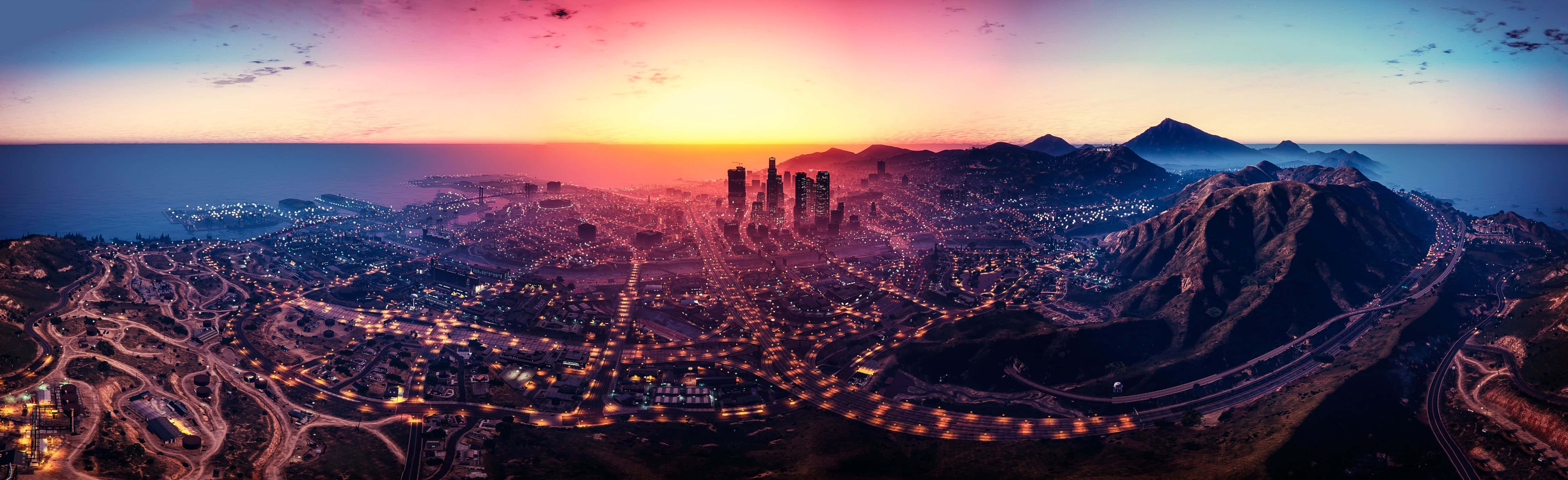 gta v 桌布 壁紙 — 山脈之間的海岸城市全景日落景觀，街道和建築物閃爍著光芒。