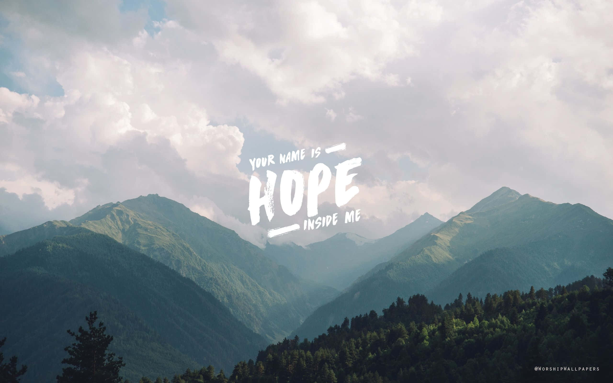 Christian Macbook 桌布 壁紙 — 山脈在陰天天空下，白色書法字體寫著「YOUR NAME IS HOPE INSIDE ME」。