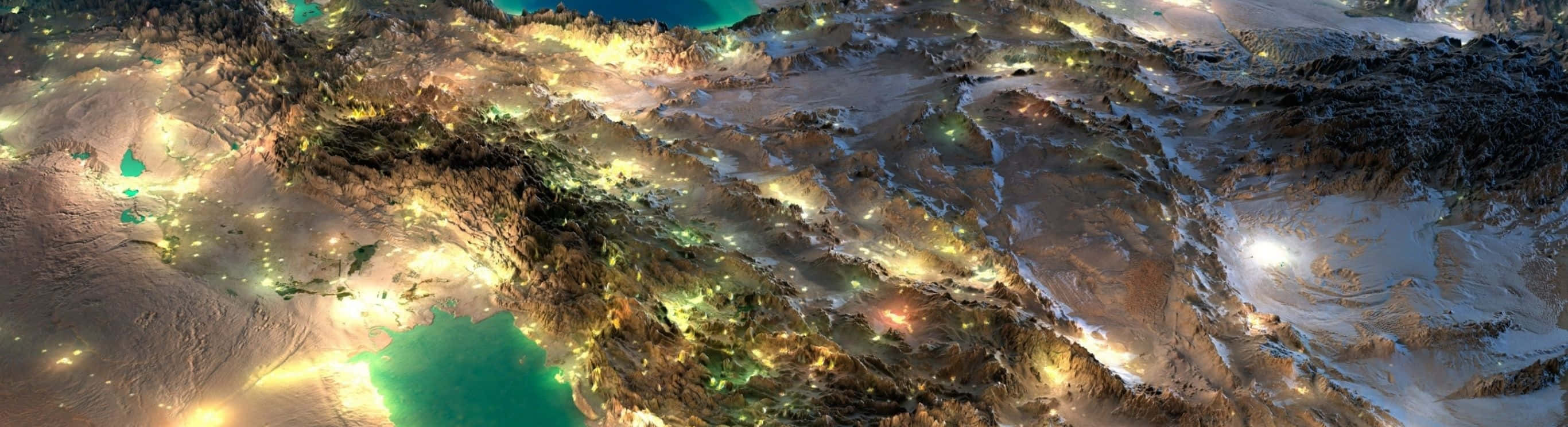 桌布 壁紙 — 崎嶇山區地形的夜間空拍圖，山谷和高原上散落著發光的城市燈光。