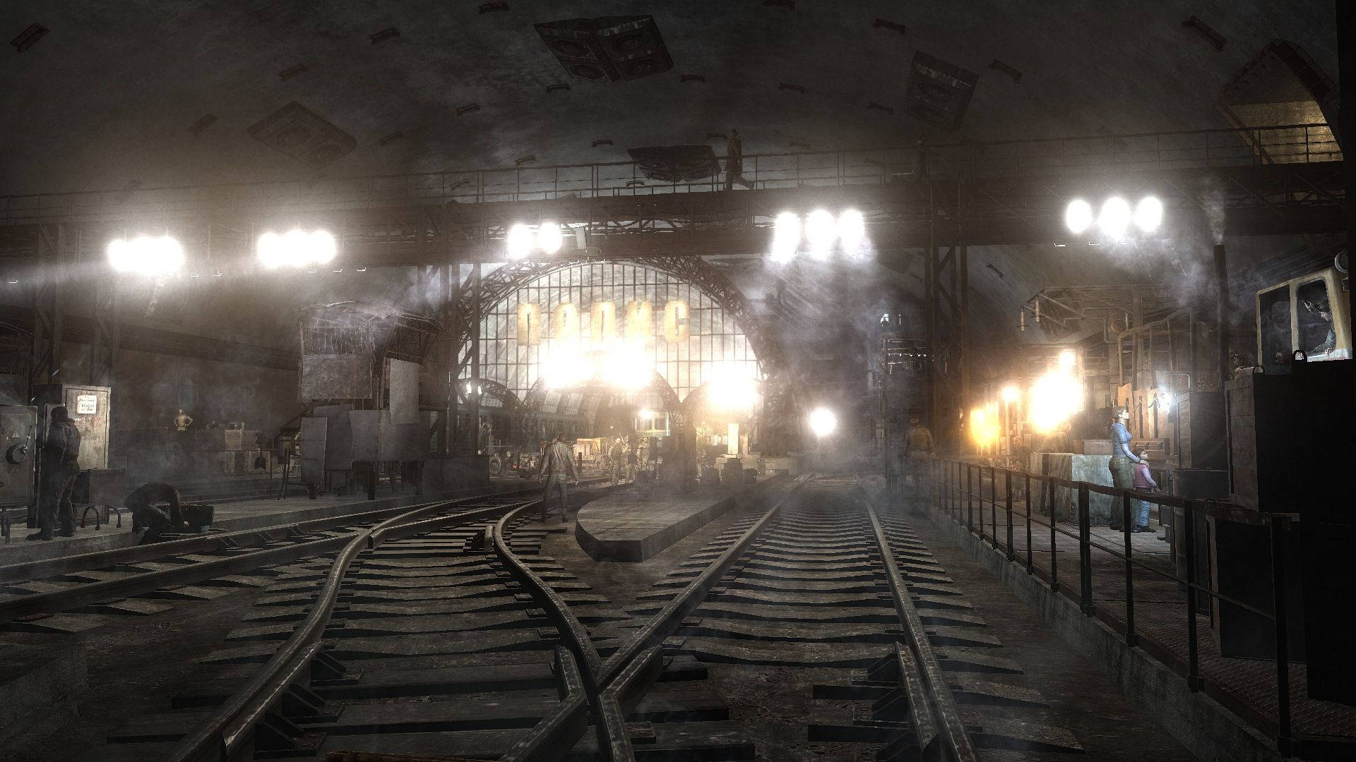 Metro Exodus 桌布 壁紙 — 工業火車站，蒸汽軌道在明亮的頭頂燈光下匯聚，處於陰暗的地下環境。