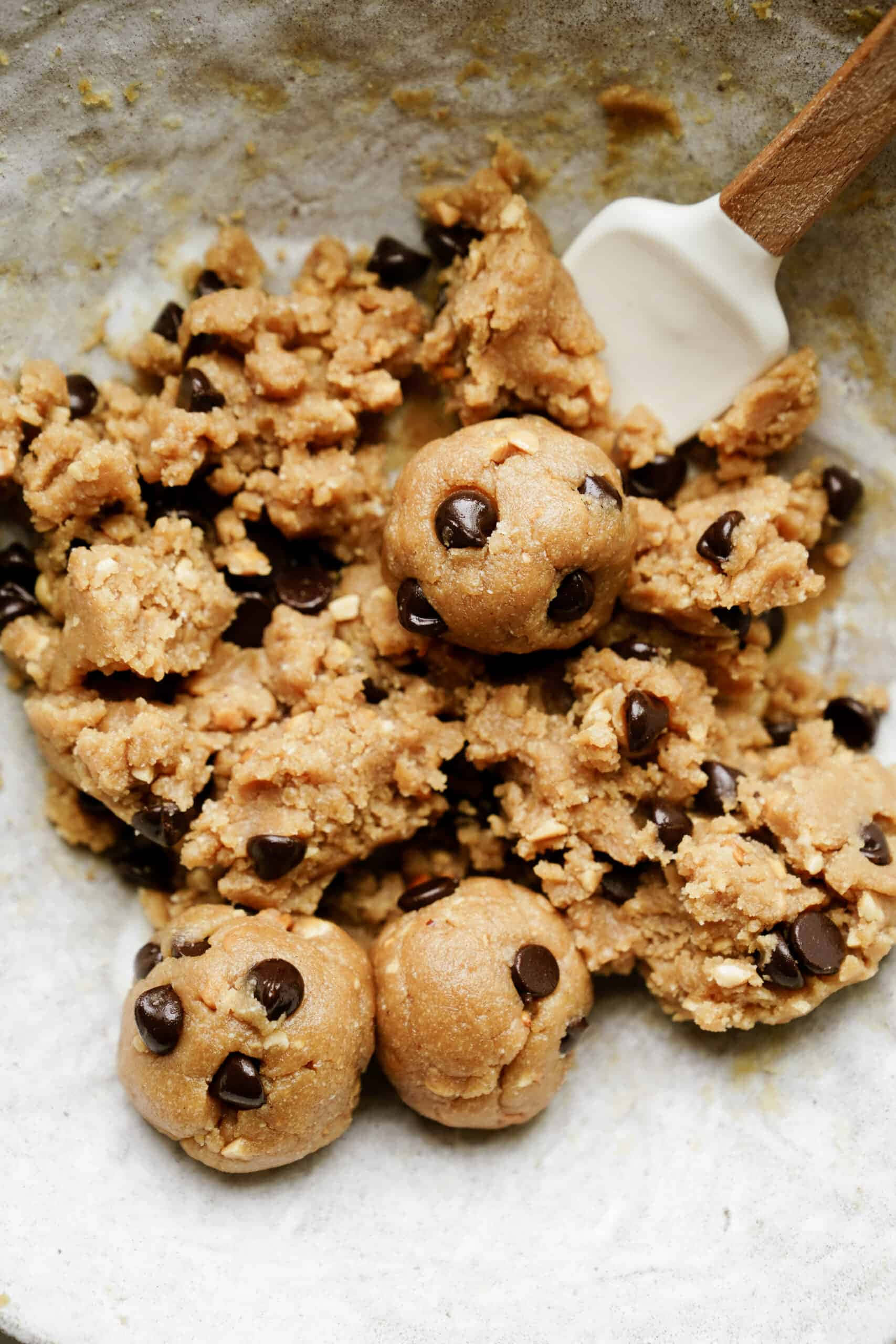 Cookie 桌布 壁紙 — 巧克力曲奇麵糰球放在攪拌碗中，配以刮刀的近距離特寫。