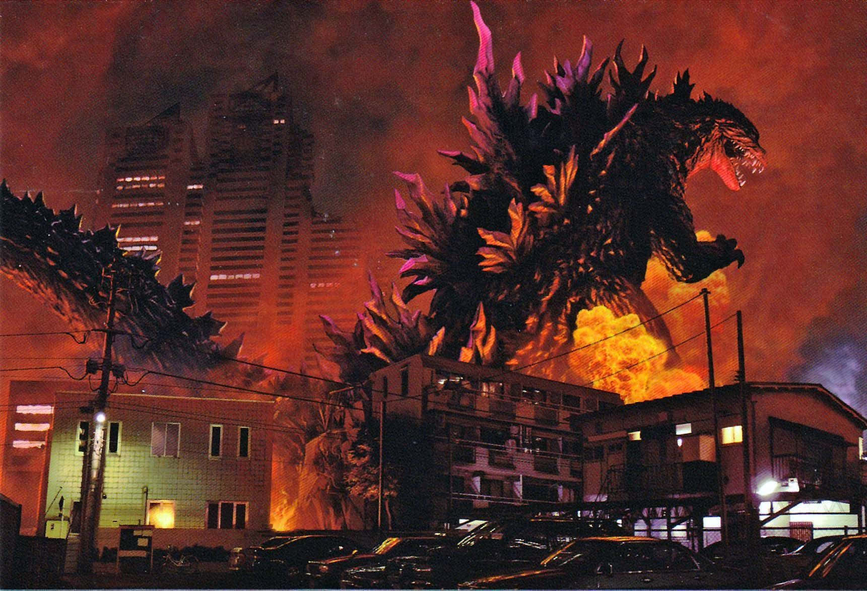 Godzilla 2000 桌布 壁紙 — 巨型哥吉拉在夜晚燃燒的城市景觀中，在烈火毀滅中咆哮。
