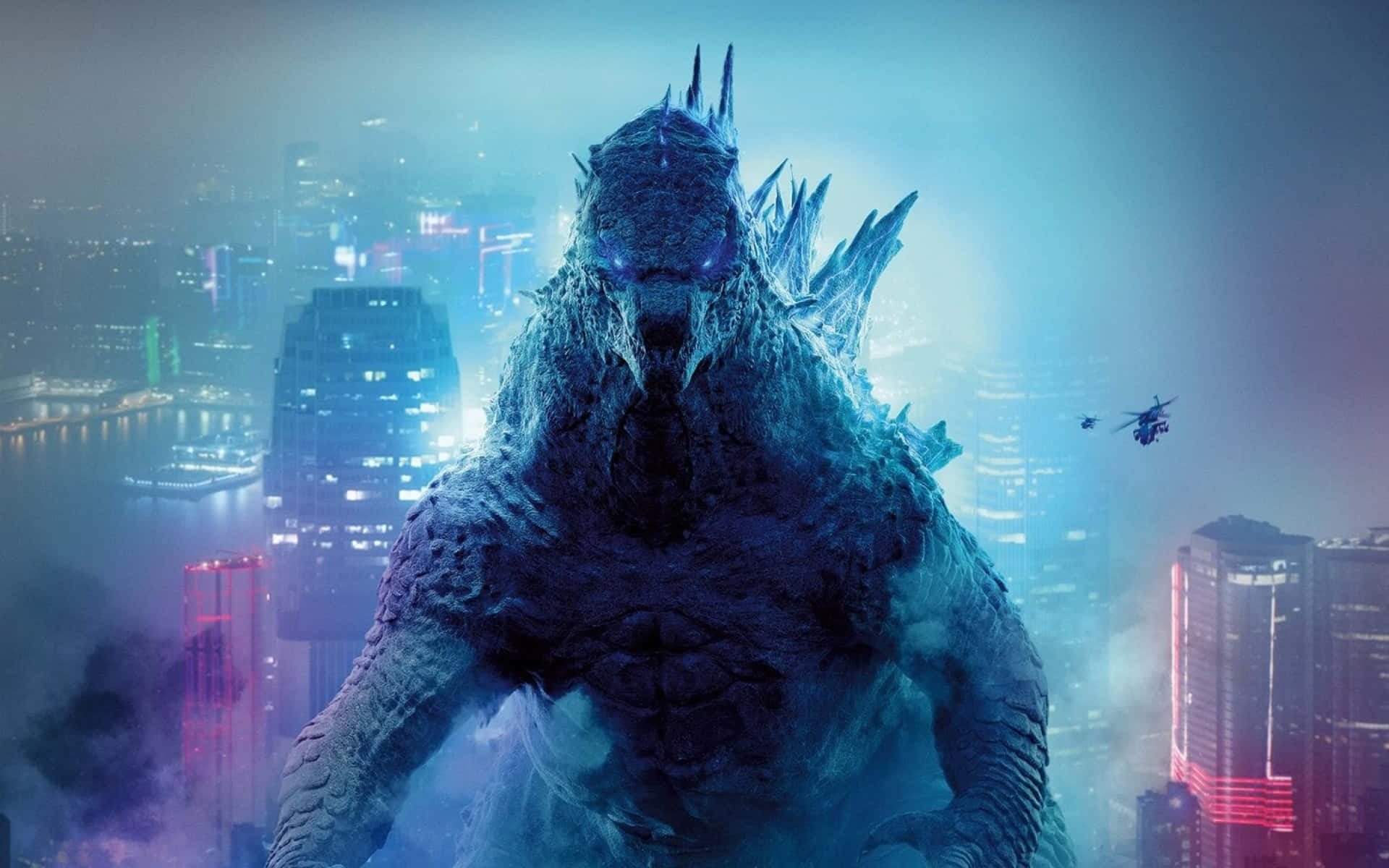 monsters 桌布 壁紙 — 巨型哥吉拉在夜晚籠罩著霓虹燈閃爍的城市景觀，附近有直升機飛過。