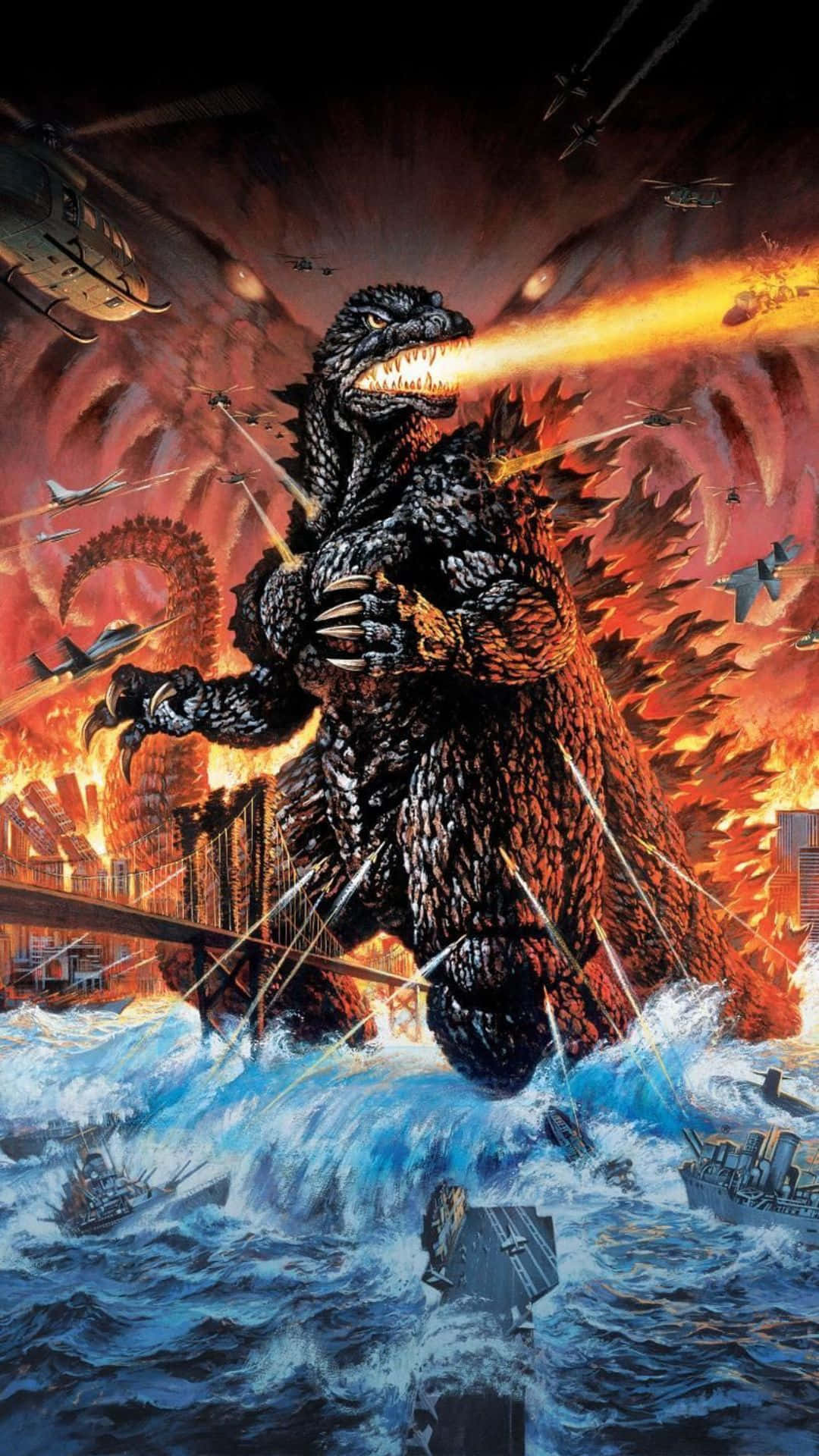 Godzilla 2000 桌布 壁紙 — 巨型哥吉拉從海洋水域中出現，噴射原子火焰，而飛機和直升機在燃燒的城市景觀中攻擊。