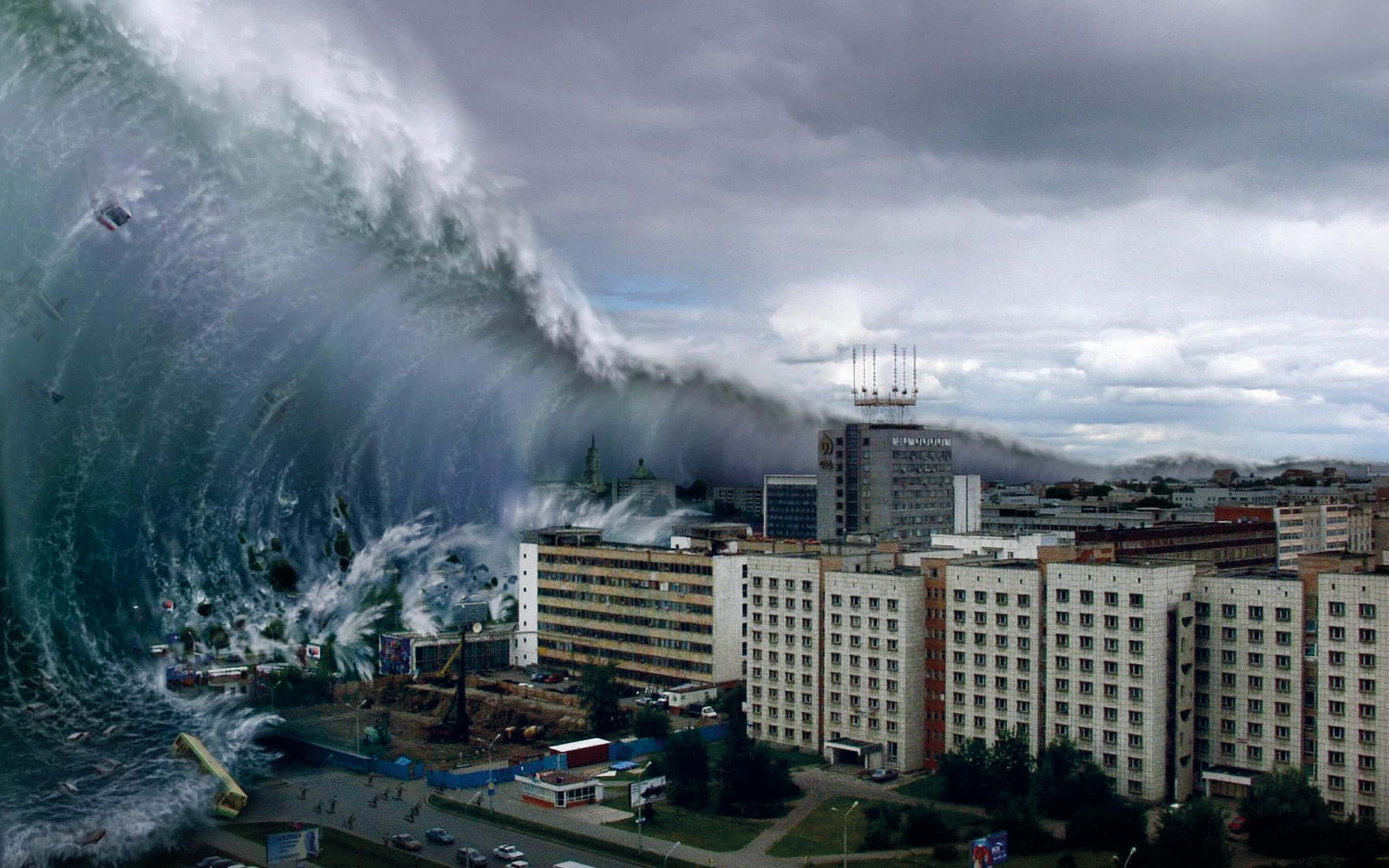 Natural Disaster 桌布 壁紙 — 巨大的海嘯波浪沖擊城市，在暴風雨的天空下吞噬建築物和街道。