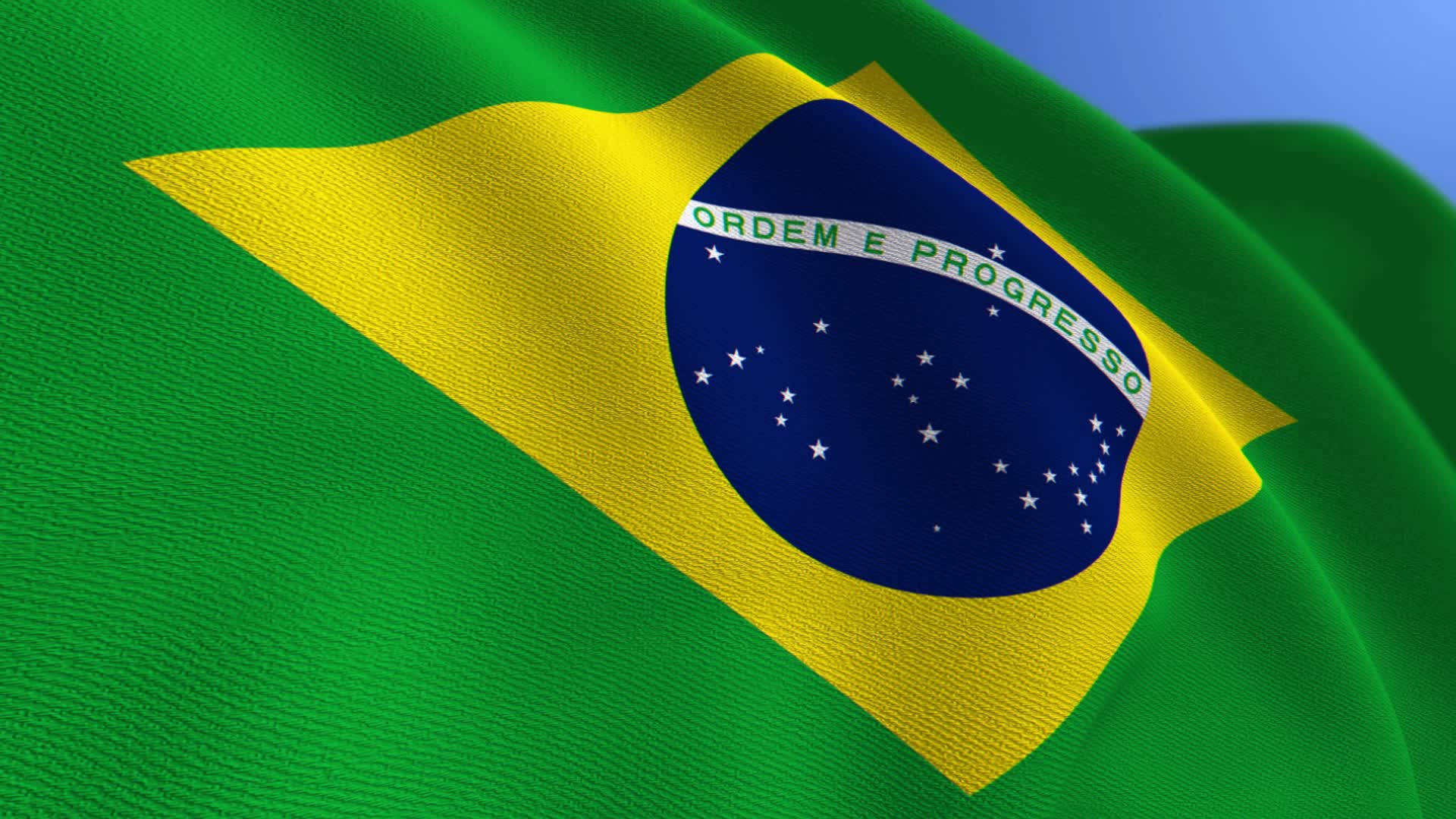 Brazil Flag 桌布 壁紙 — 巴西國旗，帶有綠色、黃色、藍色星星和格言，在晴朗的藍天下隨風飄揚。