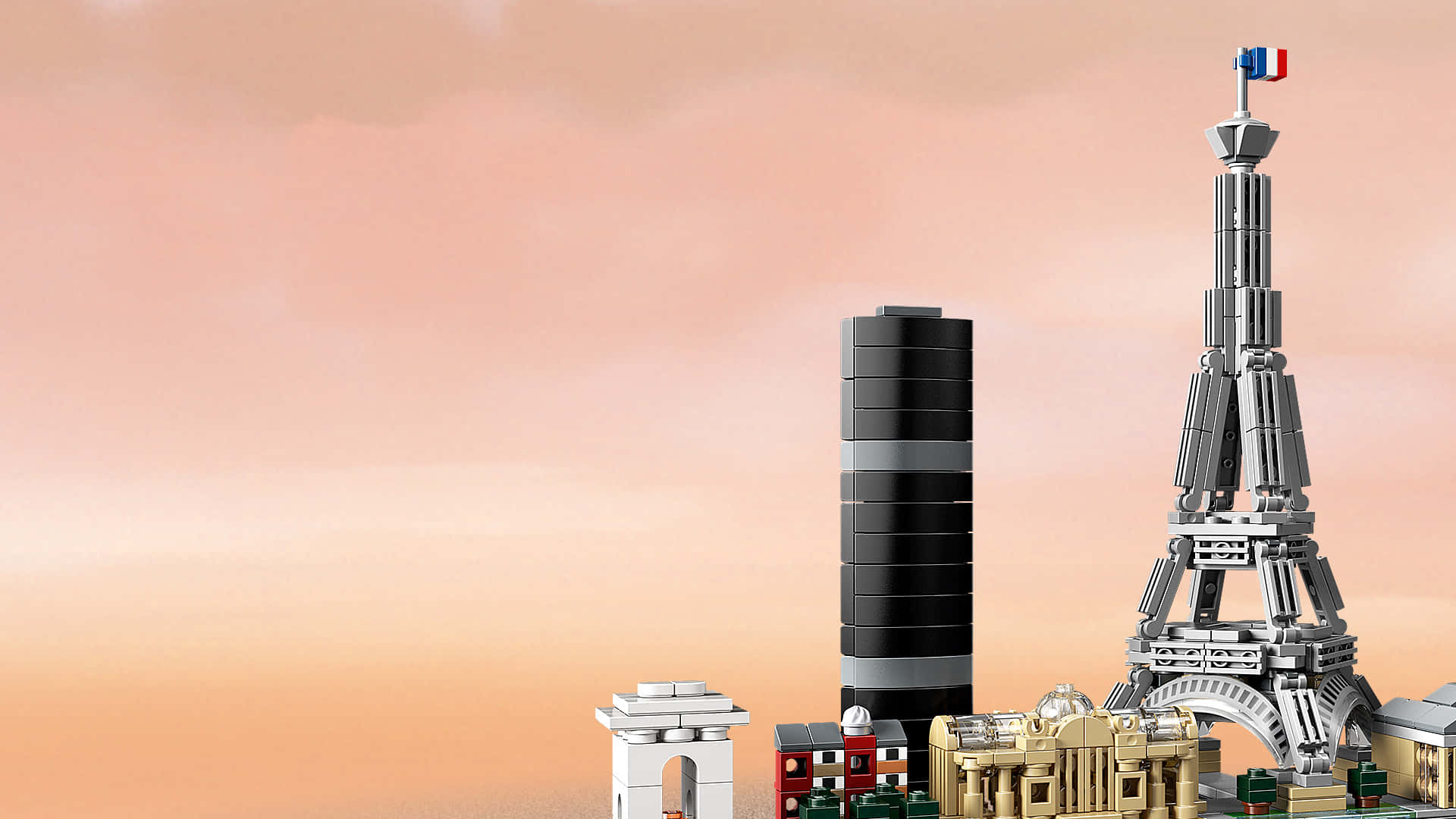 樂高 桌布 壁紙 — 巴黎地標的LEGO模型，包括頂部有法國國旗的艾菲爾鐵塔，背景是柔和的桃色日落天空。