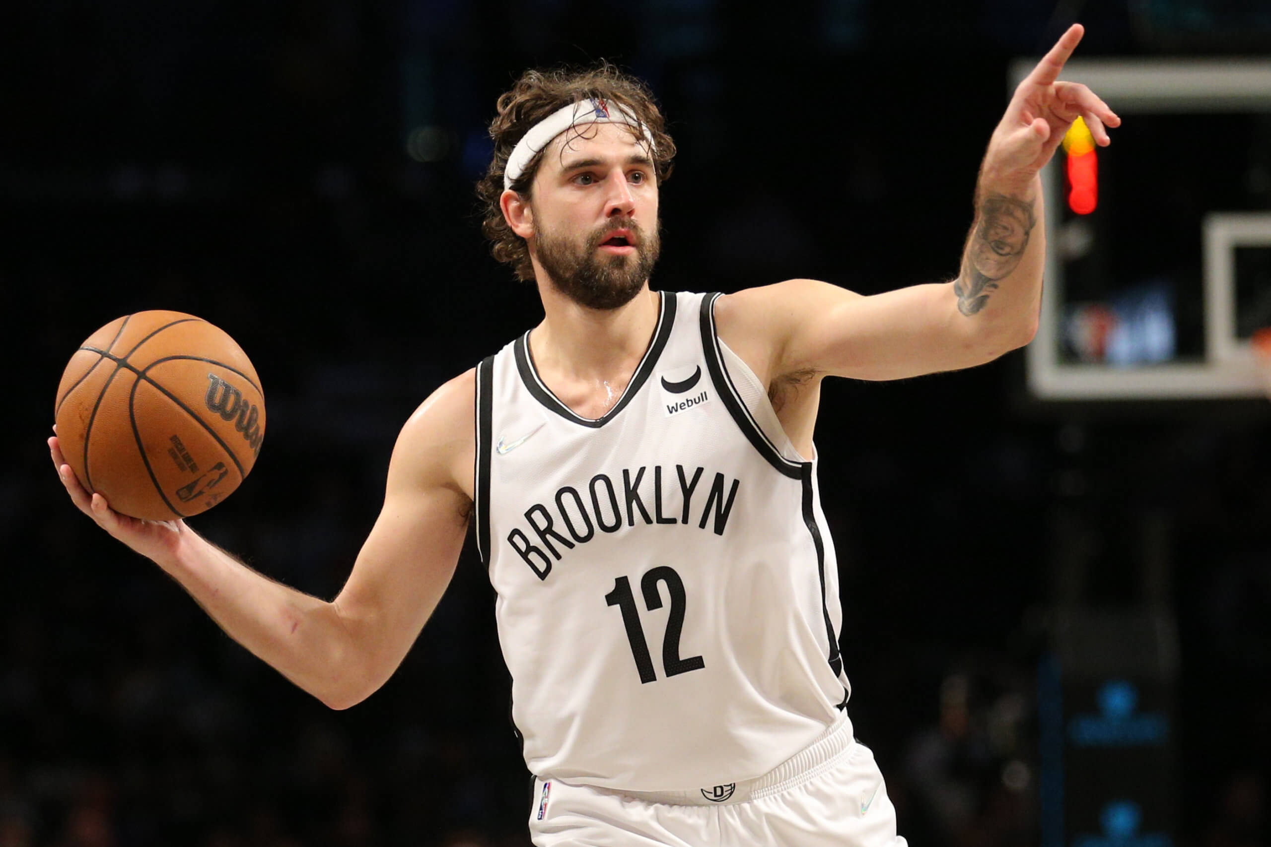 joe harris 桌布 壁紙 — 布魯克林籃網隊12號球員在明亮的場館燈光下，於室內比賽中專注地運球。