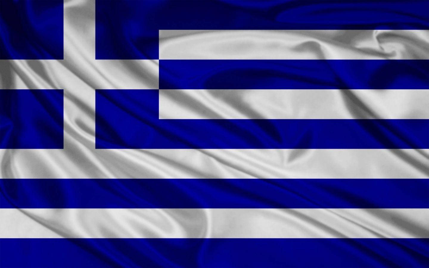 greek 桌布 壁紙 — 希臘國旗，帶有深藍色和白色條紋，以及在白色正方形上的藍色十字，在風中動態飄揚。