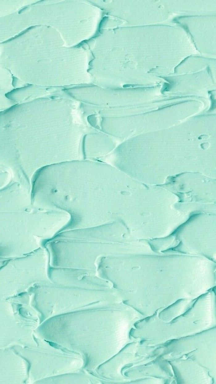 Aesthetic Green Minimal 桌布 壁紙 — 帶有光澤脊紋和漩渦紋的紋理薄荷綠色油漆特寫，營造出光滑的抽象表面。