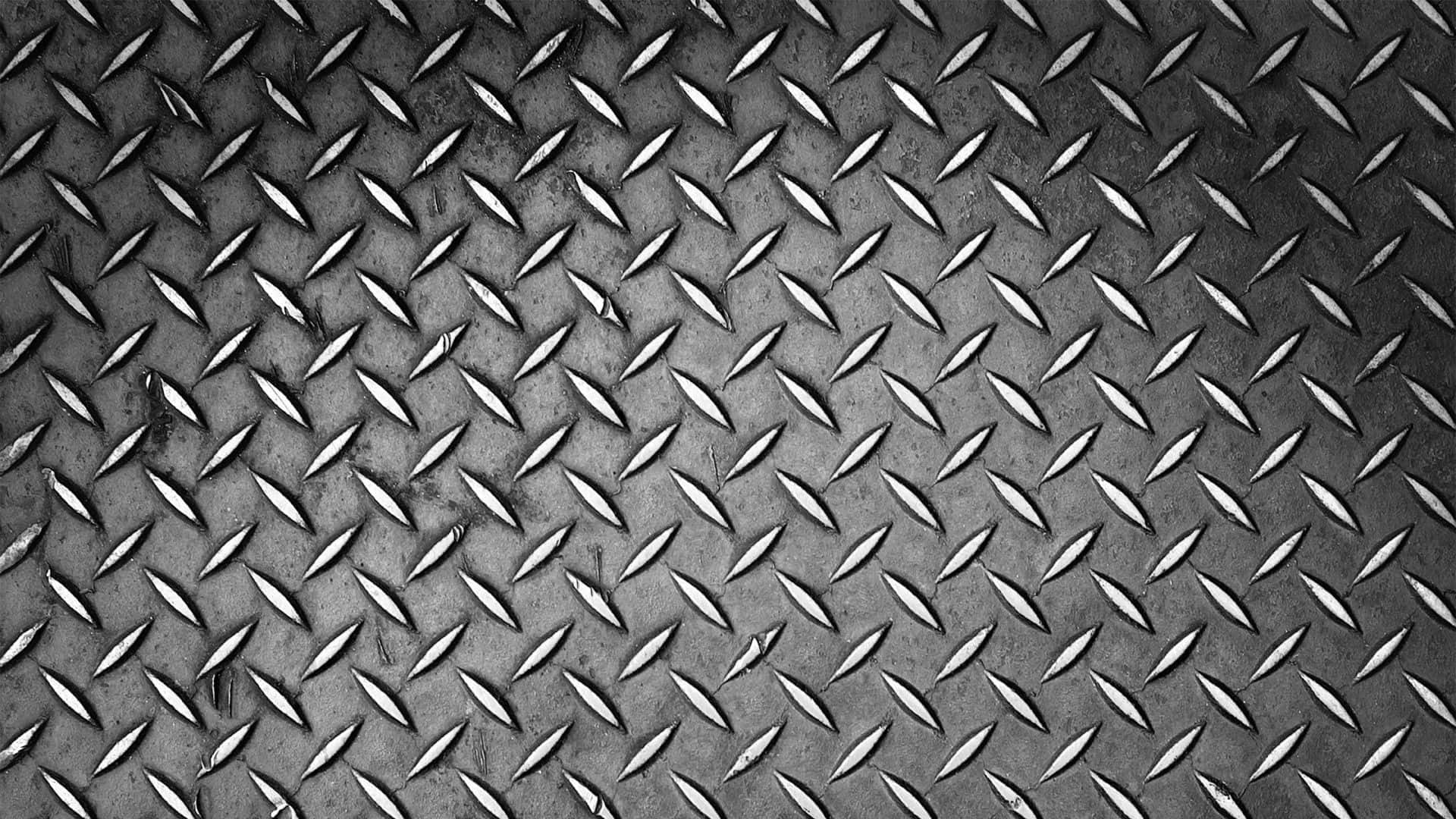 metal 桌布 壁紙 — 帶有工業灰色調和細微磨損痕跡的紋理鑽石板金屬特寫。