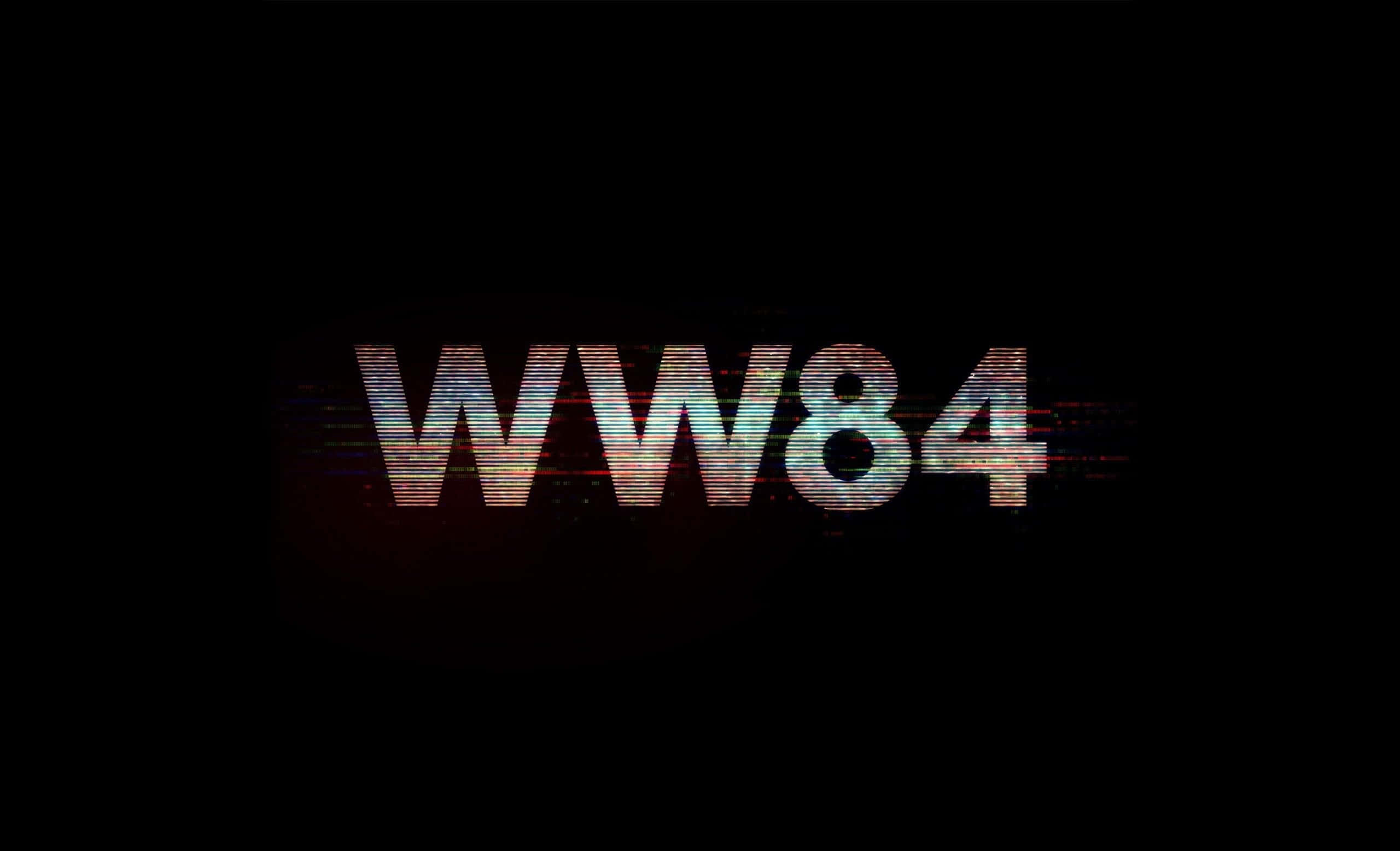 神力女超人 桌布 壁紙 — 帶有故障效果的 WW84 文字在黑色背景上脈動，呈現扭曲的彩虹色調。