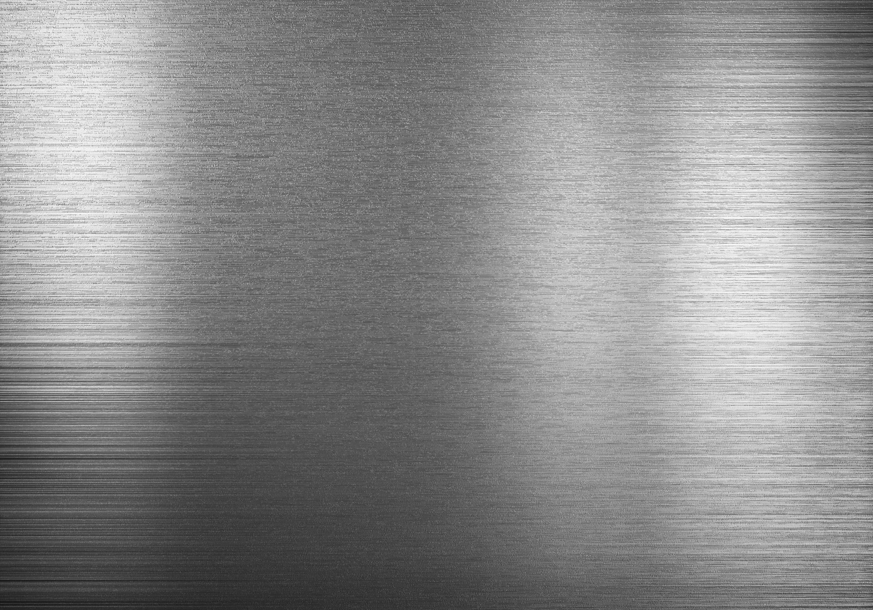 Metallic 桌布 壁紙 — 帶有水平線條及由左至右漸變光反射的拉絲金屬表面。