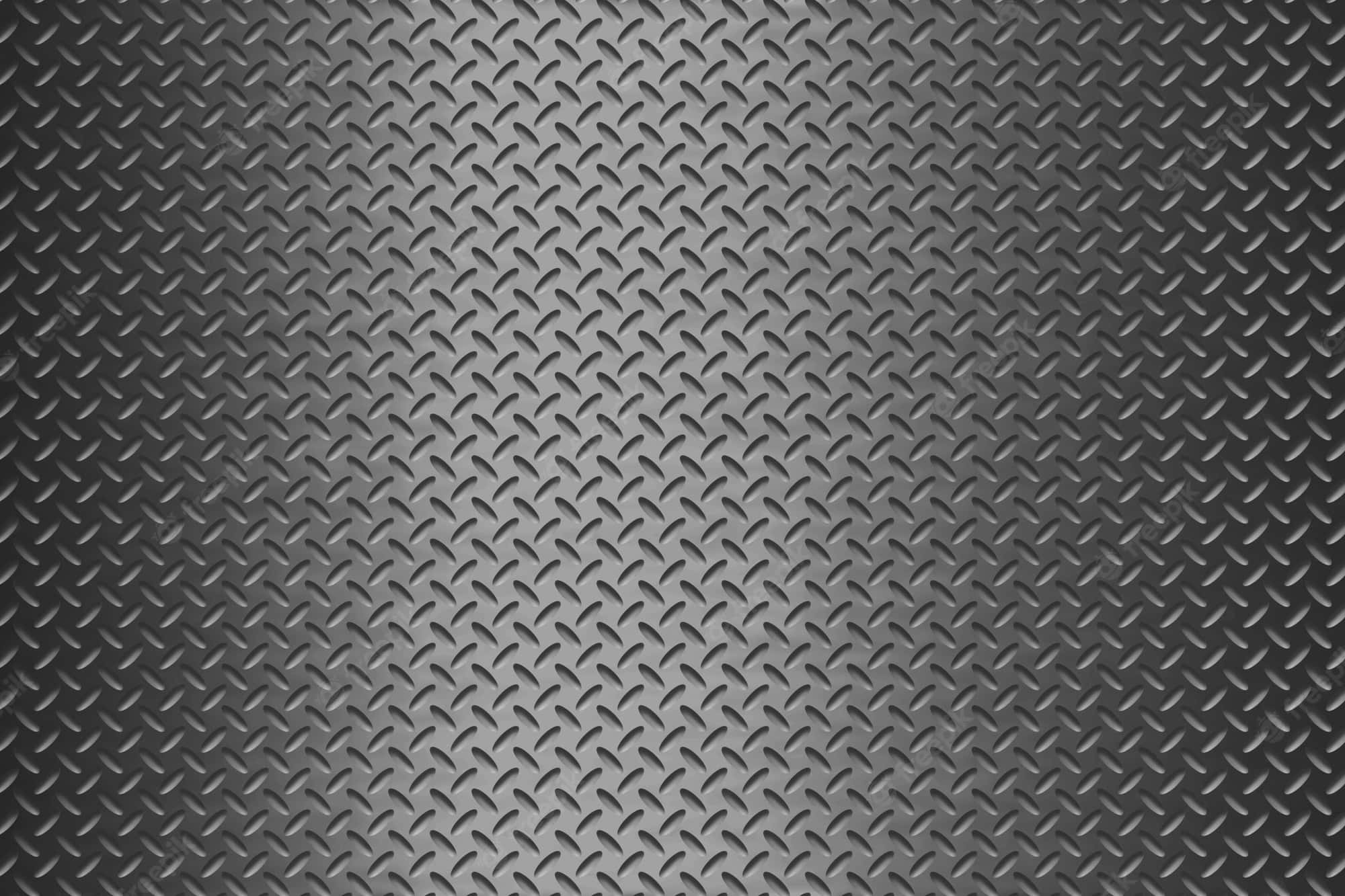 Diamond Plate 桌布 壁紙 — 帶有漸變灰色色調和細微光反射的紋理菱形板金屬表面特寫。