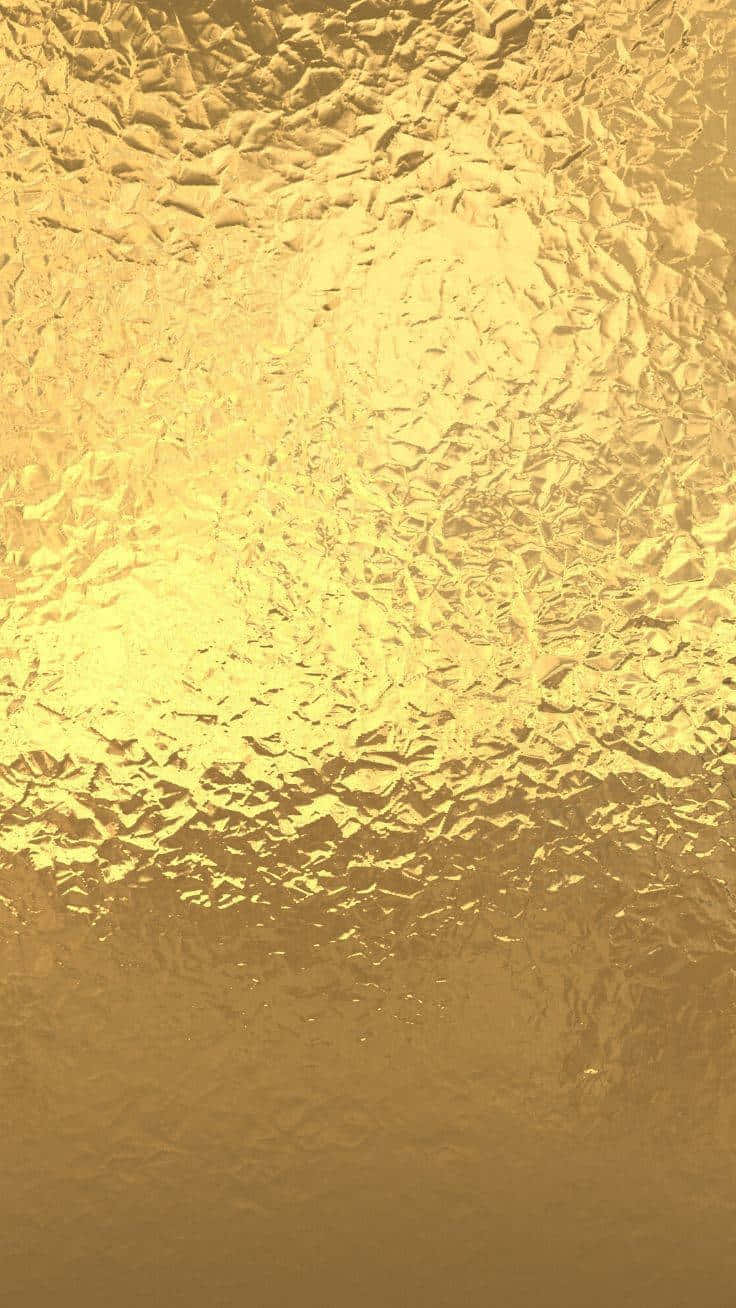 Gold Texture 桌布 壁紙 — 帶有皺褶摺痕和從明亮中心到柔和邊緣漸變照明的紋理金色箔面。