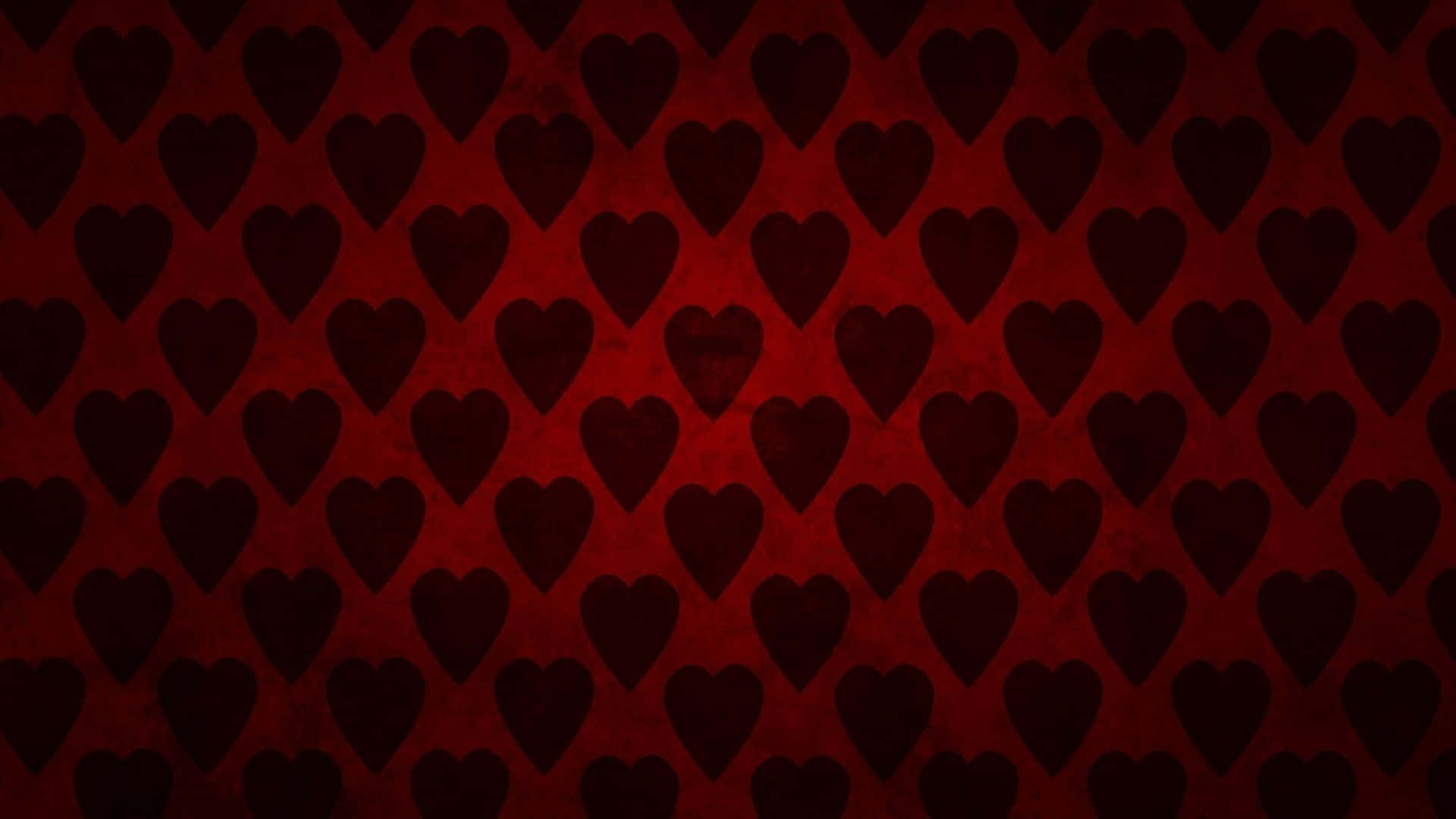 Red Hearts 桌布 壁紙 — 帶有紋理的深紅色壁紙，重複的深色心形剪影呈現微妙的漸變效果。