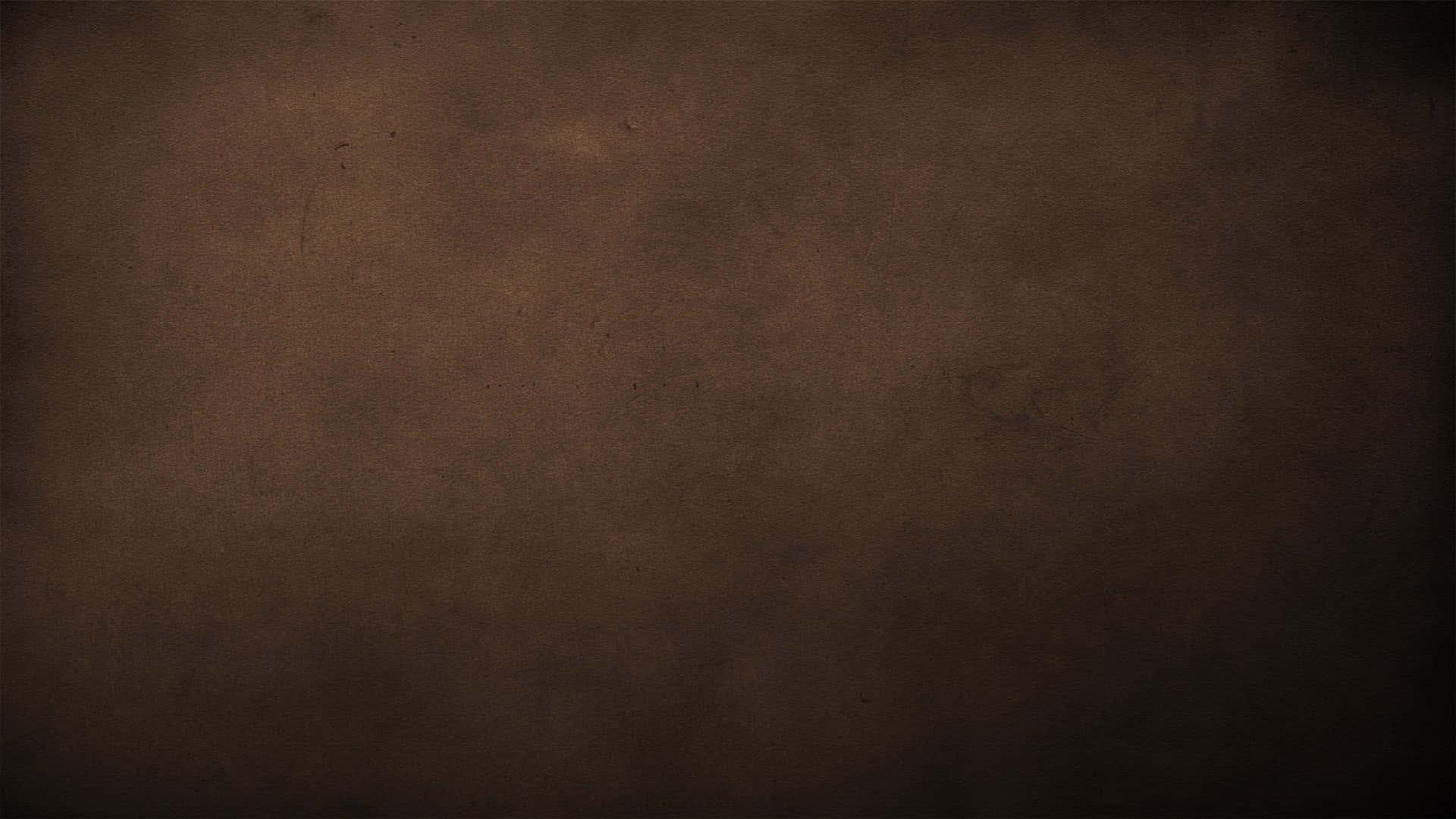 Dark Brown 桌布 壁紙 — 帶有細微紋理和褪色邊緣的深棕色復古紙張背景。