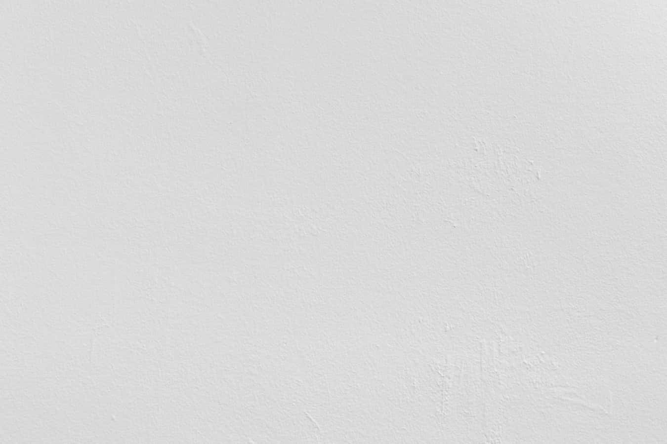 White Wall 桌布 壁紙 — 平滑白色油漆牆壁的特寫，帶有細微紋理和隱約的筆觸。