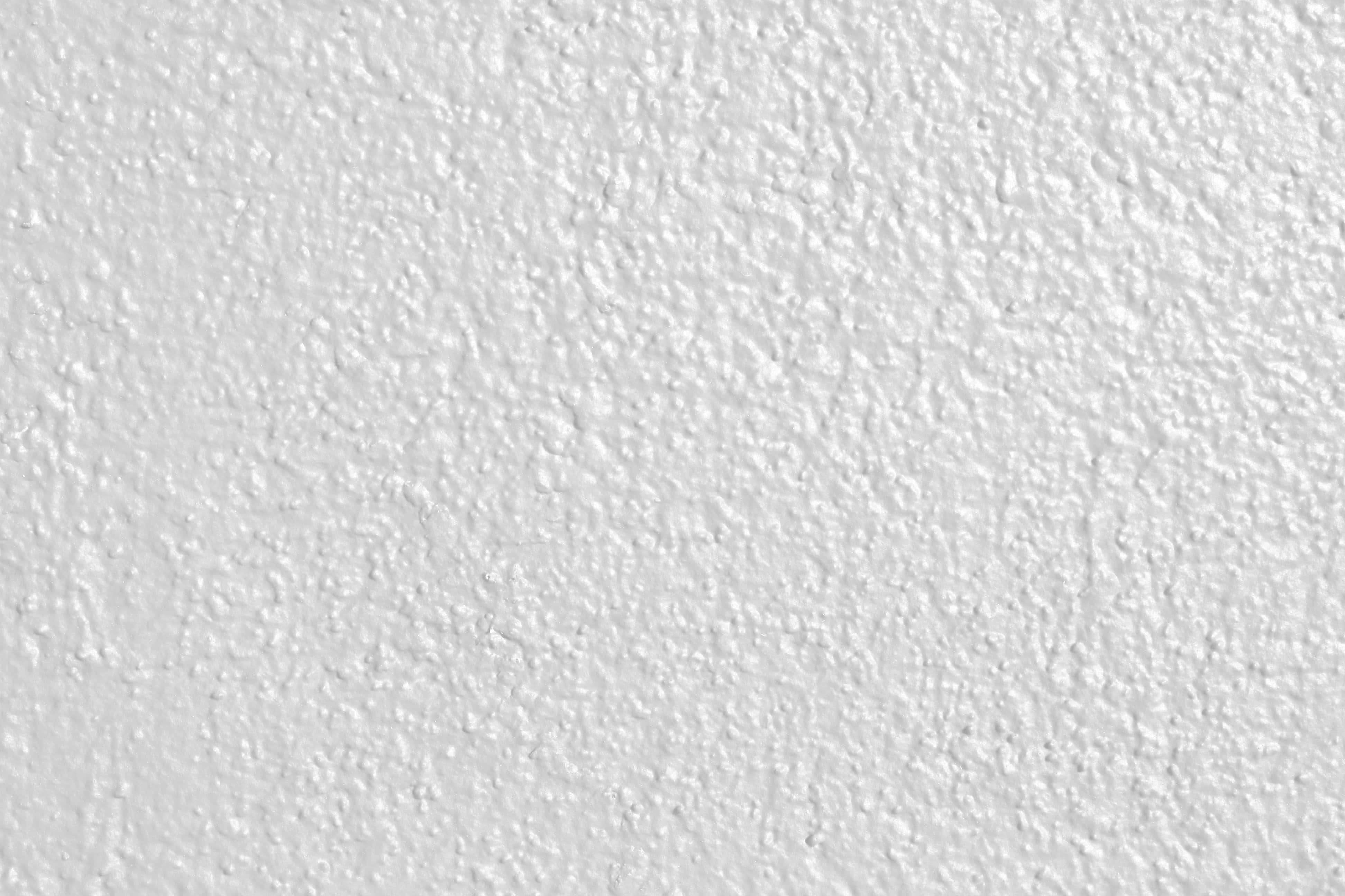 Cement 桌布 壁紙 — 平滑白色灰泥牆的特寫，帶有細微紋理和柔和光線。