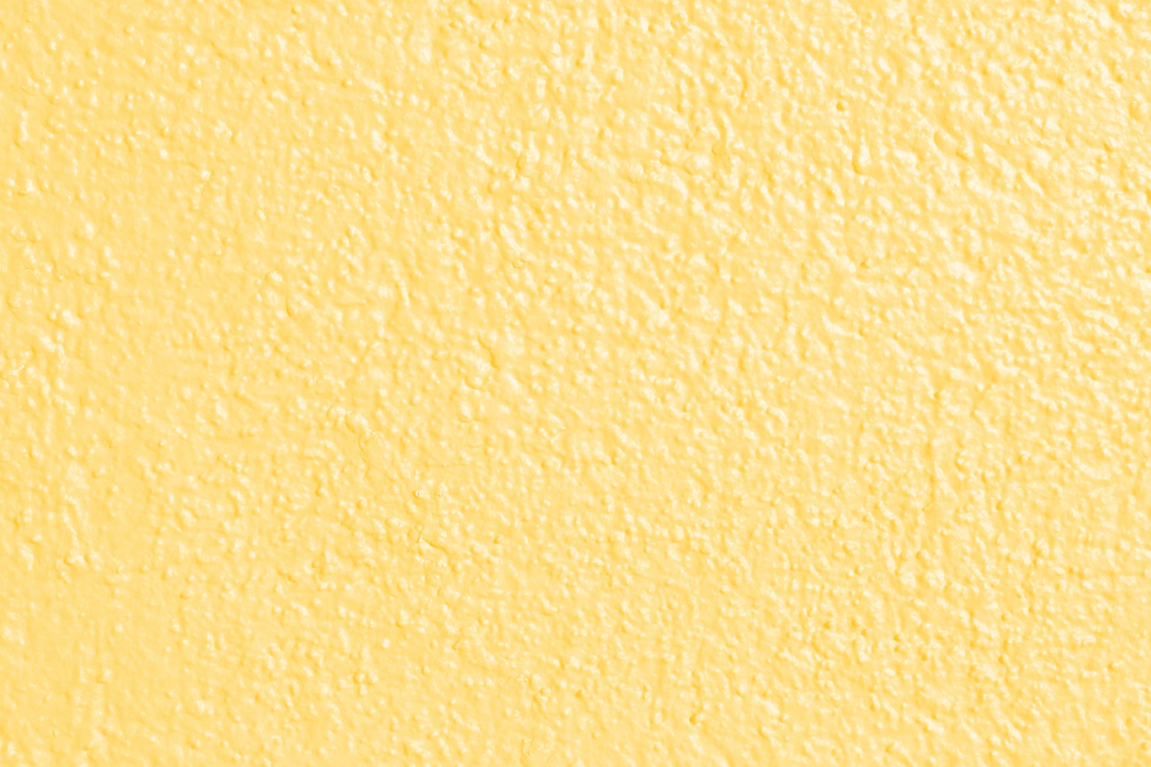 Yellow Texture 桌布 壁紙 — 平滑紋理黃色牆壁的特寫，帶有微妙的色調變化和細緻的表面細節。