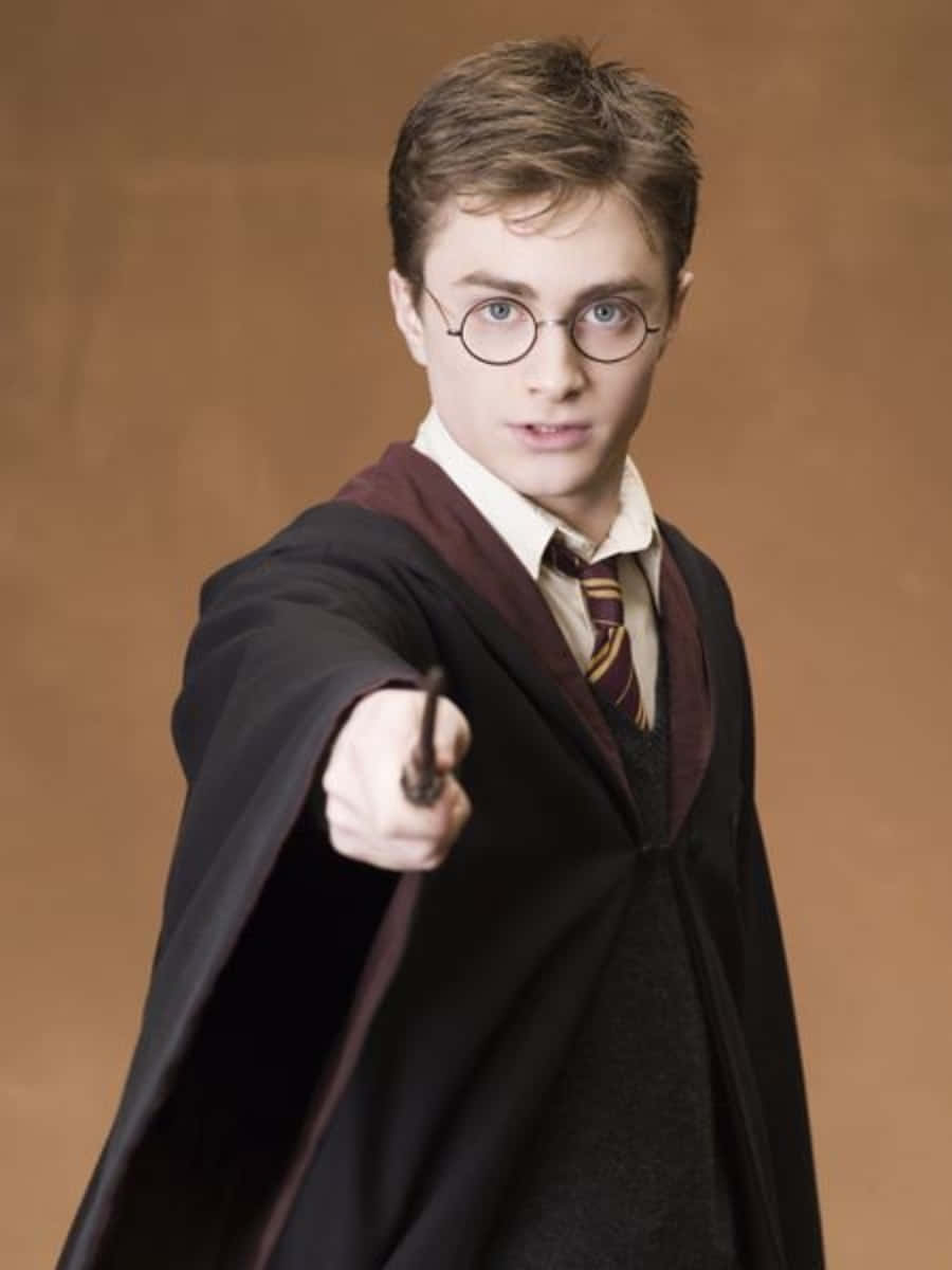 Harry Potter Profile 桌布 壁紙 — 年輕巫師哈利波特穿著葛萊芬多長袍，在溫暖的棕色背景下專注地向前揮動魔杖。