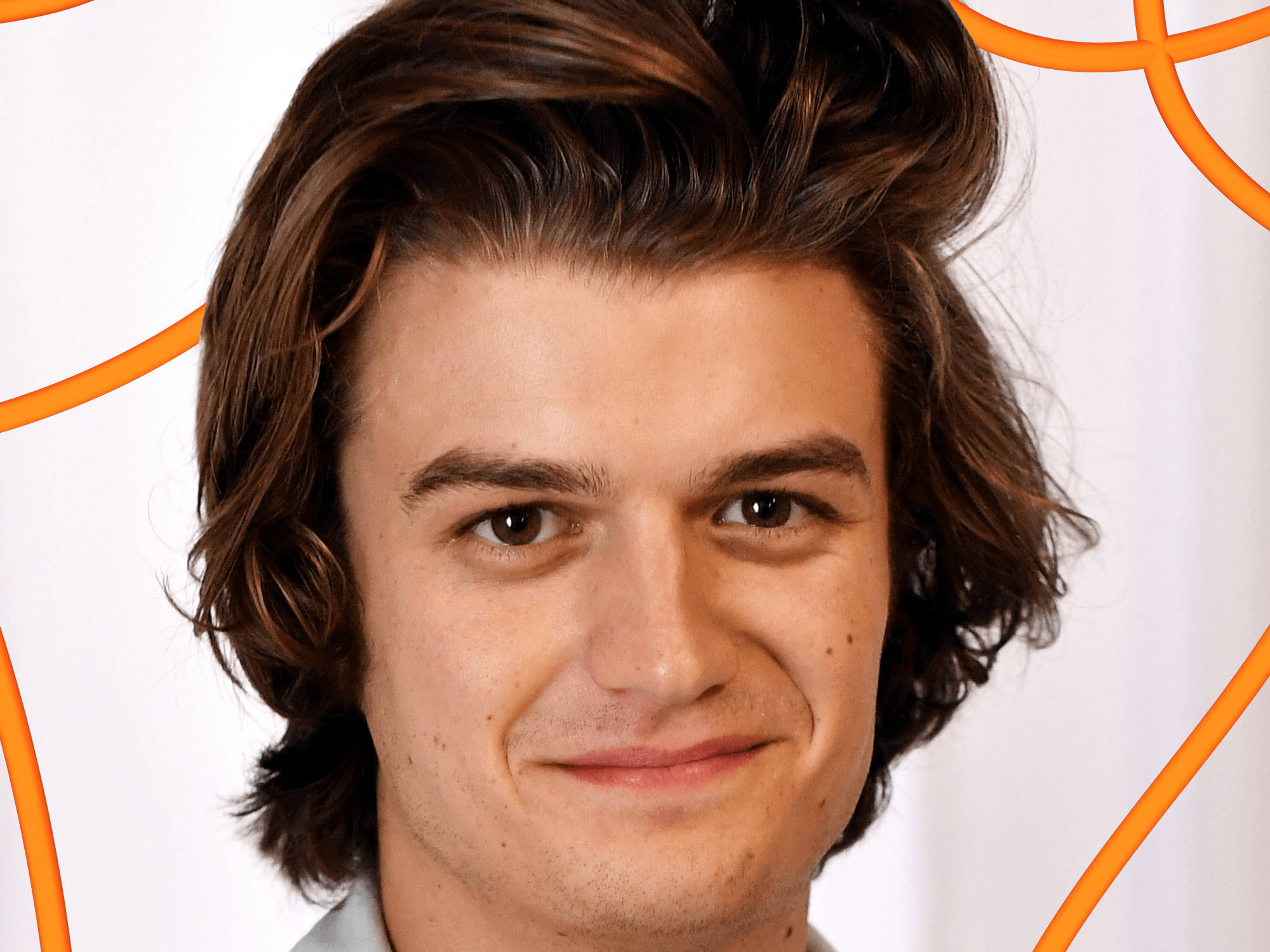 Joe Keery 桌布 壁紙 — 年輕男子波浪棕色頭髮的特寫肖像，在帶有橙色幾何線條的白色背景上柔和微笑。