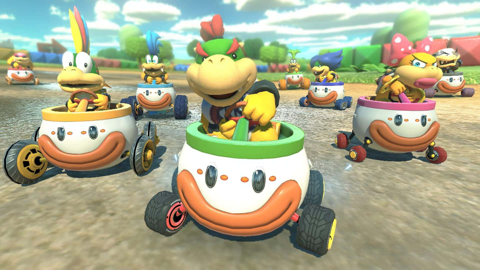 Bowser Jr 桌布 壁紙 — 庫巴和慢慢龜們在陽光明媚的賽道上駕駛色彩繽紛的杯形卡丁車比賽。