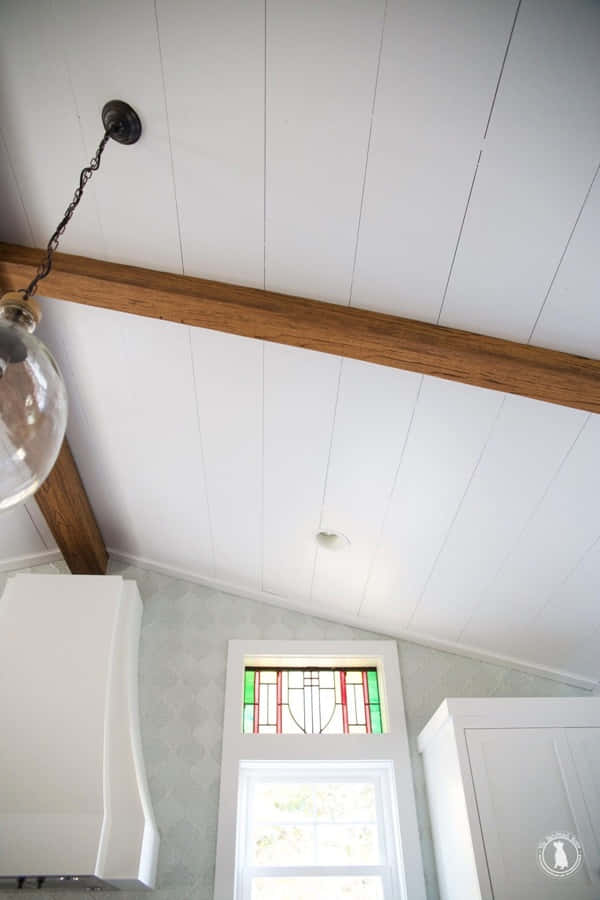 Shiplap 桌布 壁紙 — 廚房檯面上方的白色船甲板天花板，配有木樑和彩繪玻璃窗。