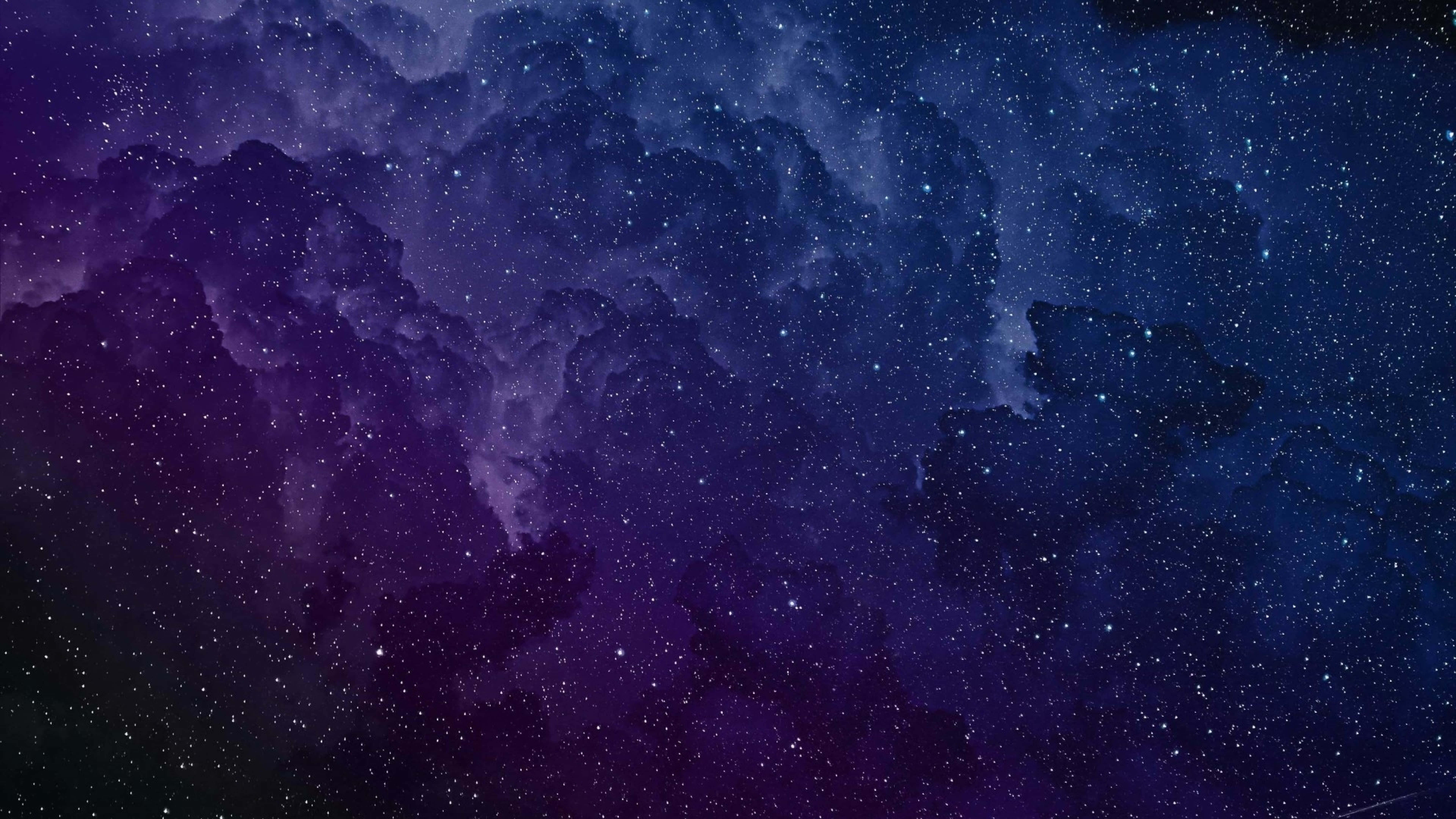桌布 壁紙 — 廣闊的宇宙星雲在深紫色和藍色中旋轉，下方是閃爍著遙遠天體光芒的星場。