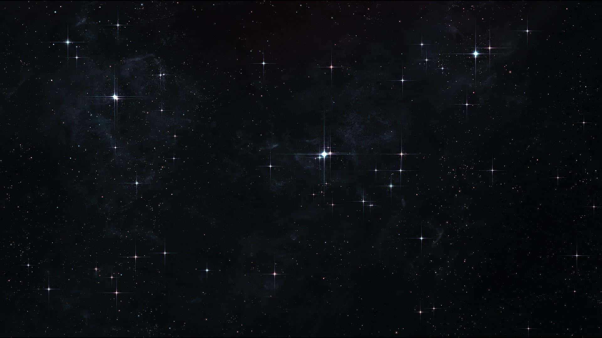 Starry Sky 桌布 壁紙 — 廣闊的宇宙空間，充滿了閃爍的星星和微妙的星雲，在深邃的黑色虛空中發光。