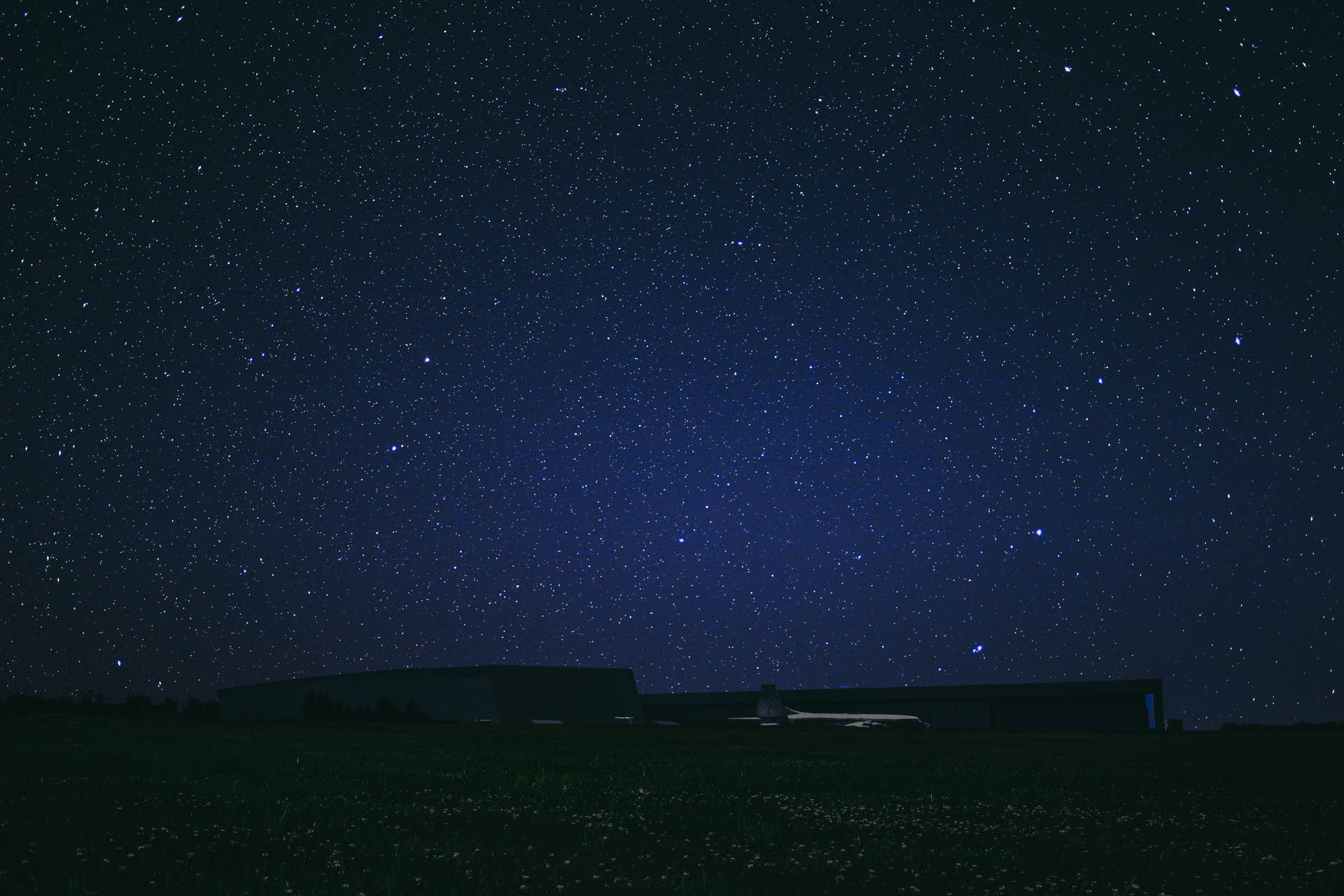 現代建築在滿天星斗的夜空襯托下呈現剪影。 — Google Meet 壁紙