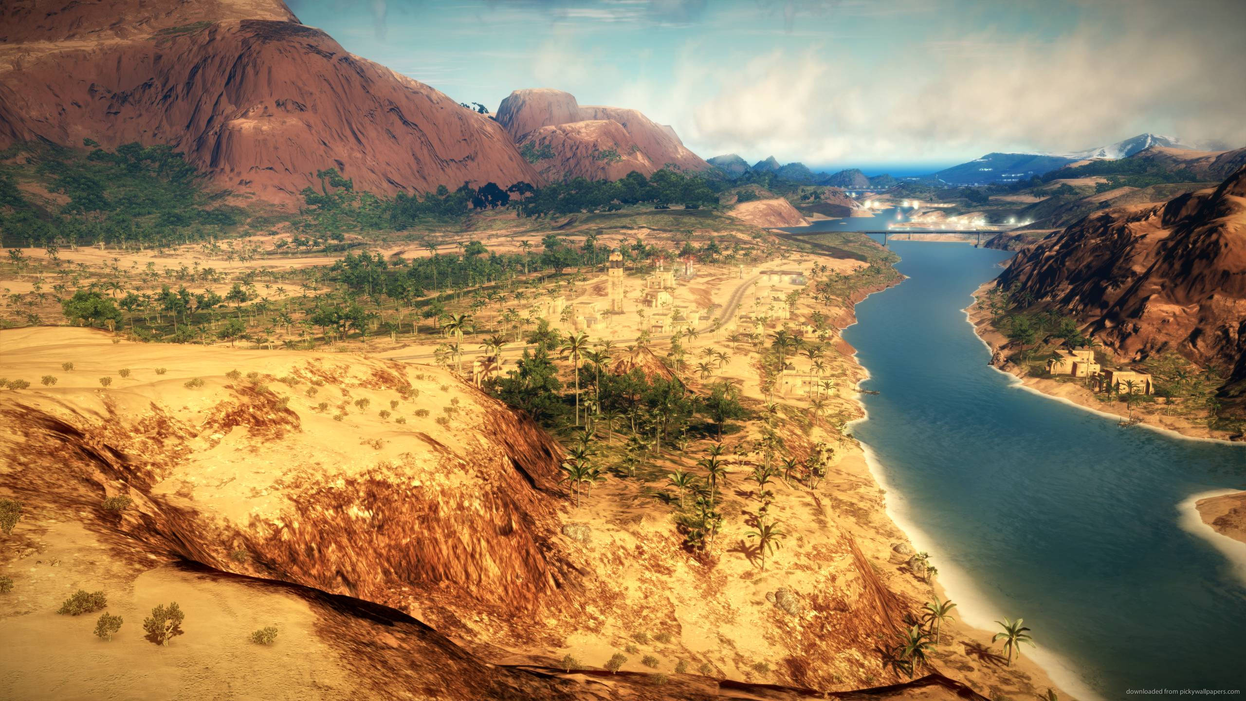 just cause 2 桌布 壁紙 — 廣闊的沙漠峽谷，蜿蜒的河流和散落的棕櫚樹，天空部分多雲。