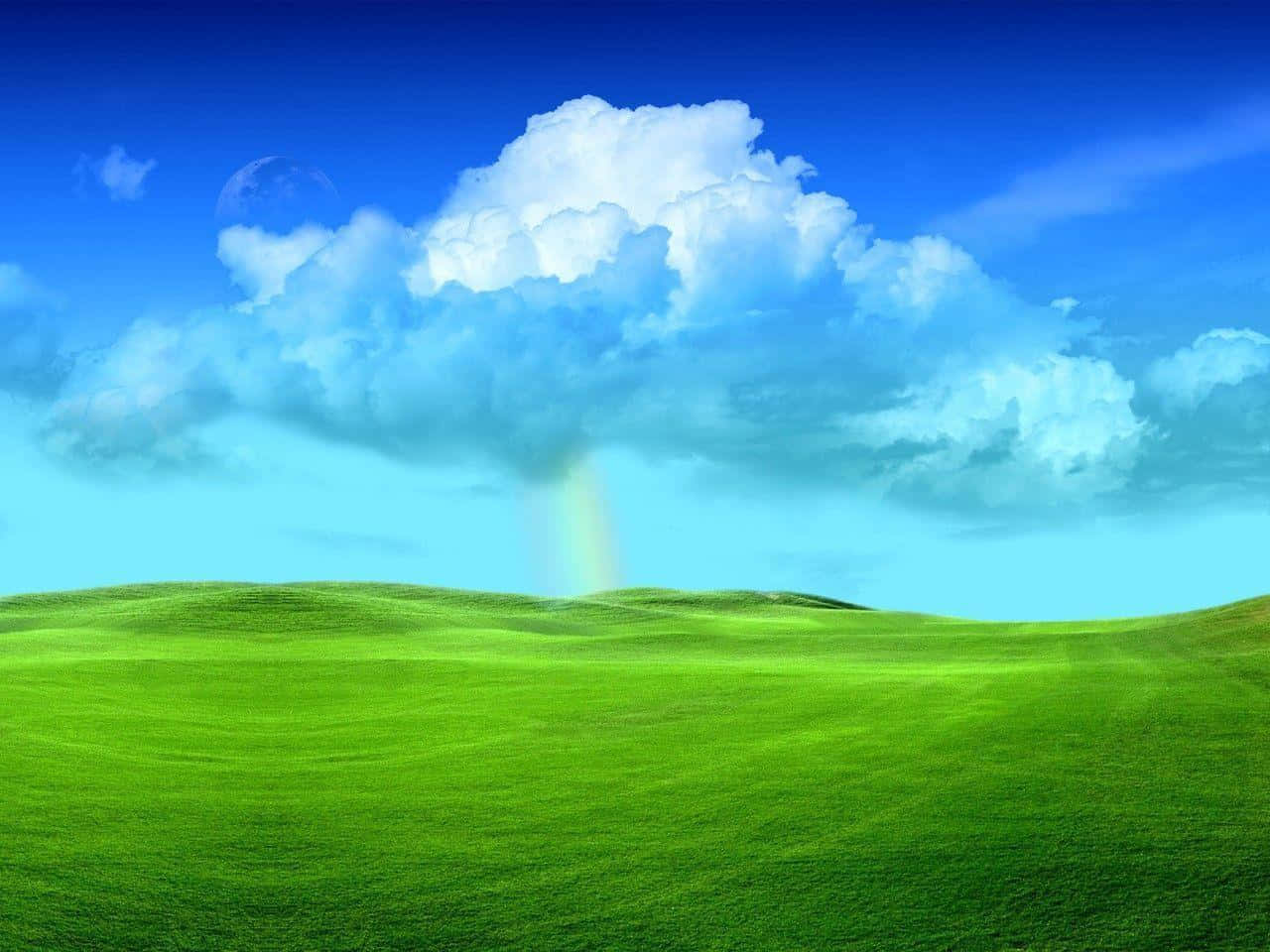 藍天下的綠色起伏山丘，雲朵下著彩虹雨。 — Windows Vista 動態圖片 壁紙