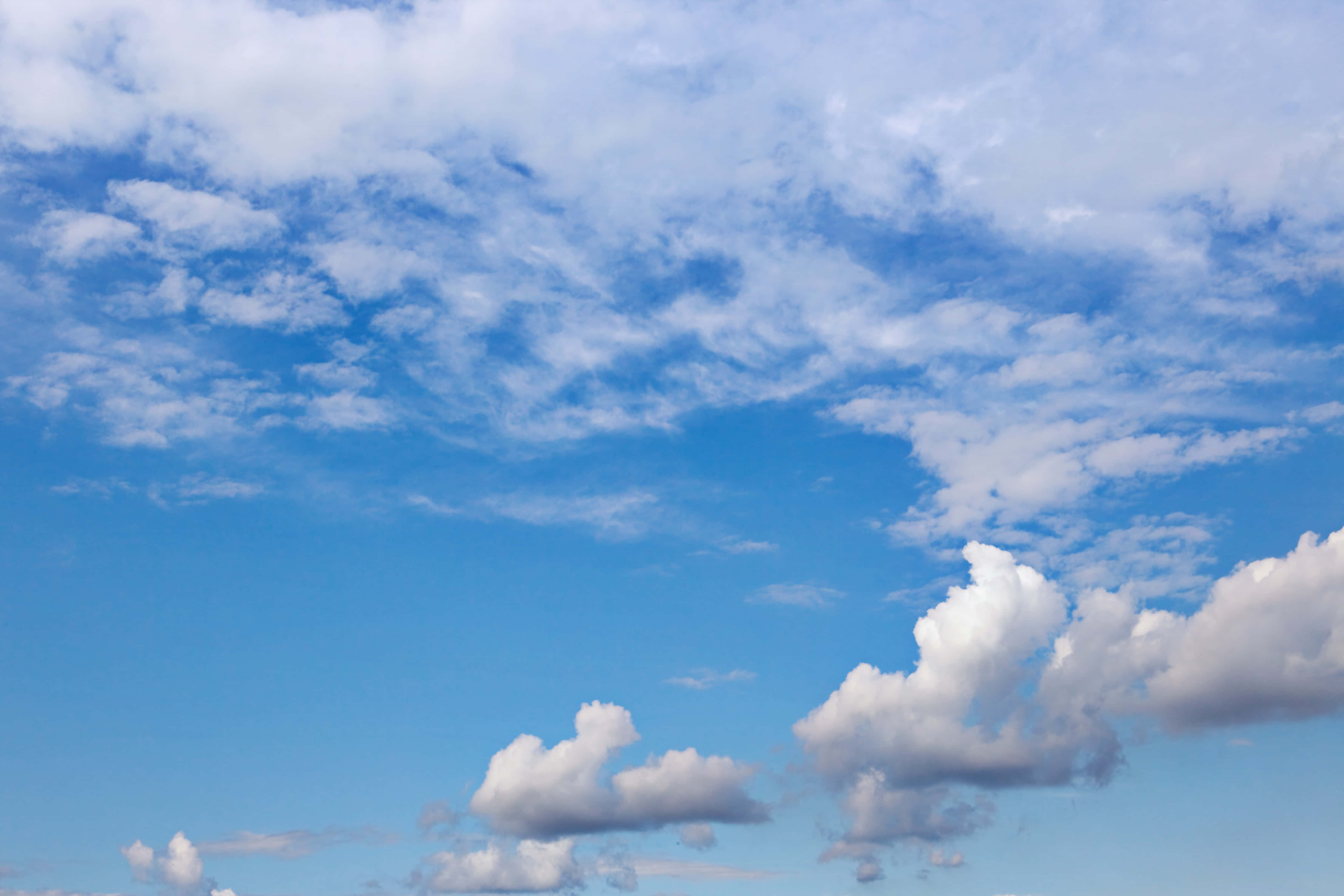 Blue Sky 桌布 壁紙 — 廣闊藍天，佈滿蓬鬆白雲，在晴朗的白天地平線上飄移。