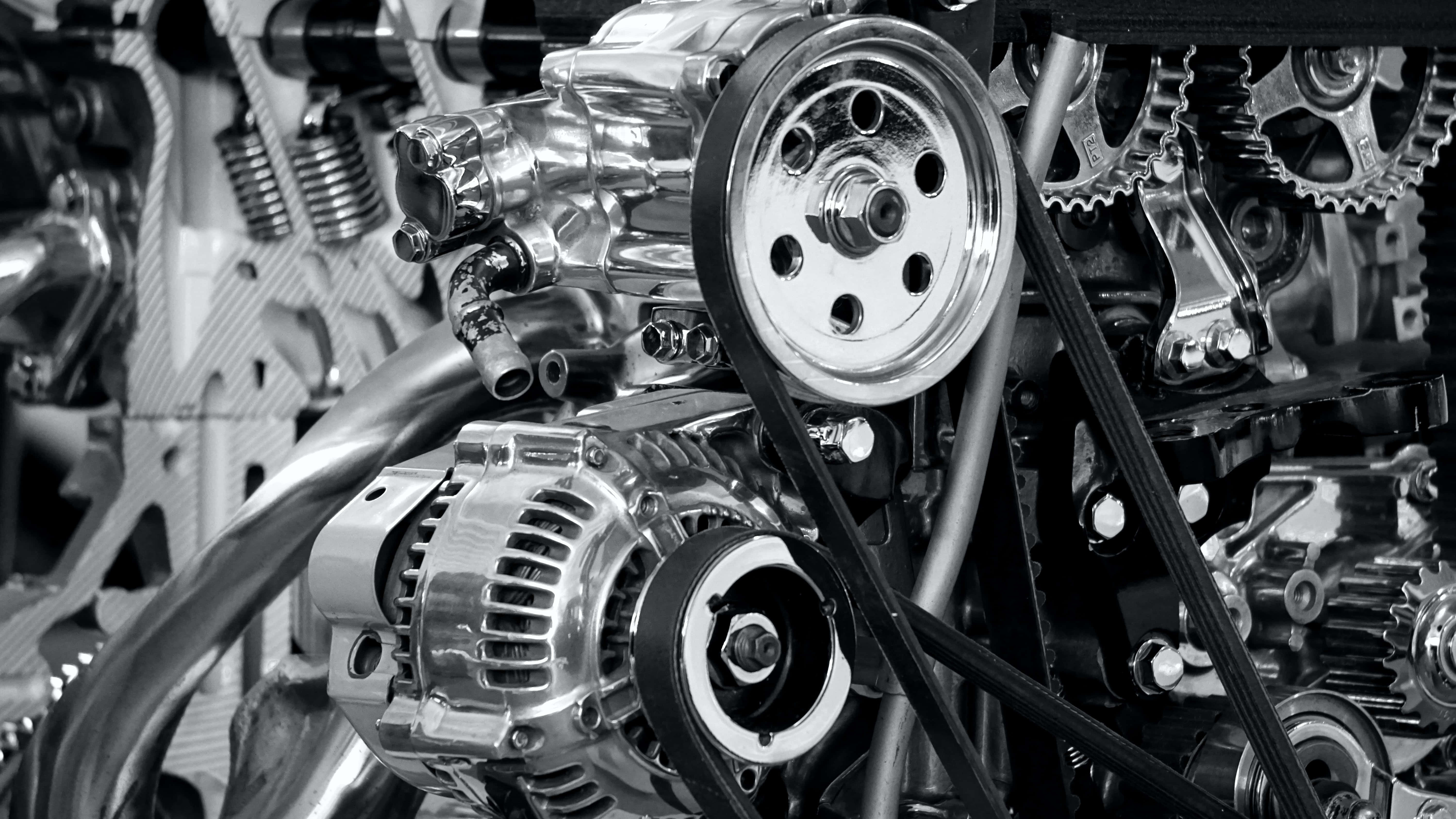 Mechanical Engineering 桌布 壁紙 — 引擎特寫黑白照片，皮帶、齒輪和發電機清晰對焦，閃閃發光。