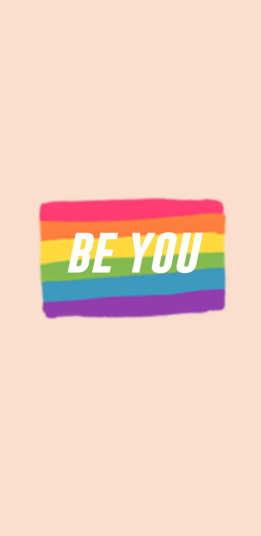 彩虹 桌布 壁紙 — 彩虹旗，中央有粗體白色文字「BE YOU」，置於柔和蜜桃色背景上。