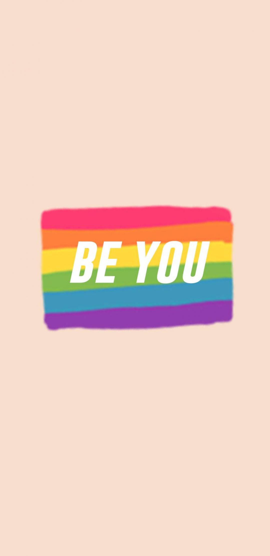 Peach 桌布 壁紙 — 彩虹旗，中央有粗體白色文字「BE YOU」，背景為柔和蜜桃色。