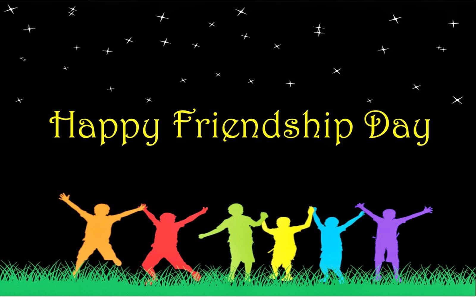 Friendship Day 桌布 壁紙 — 彩虹色兒童剪影在星空下的草地上歡樂跳躍，帶有「Happy Friendship Day」文字。