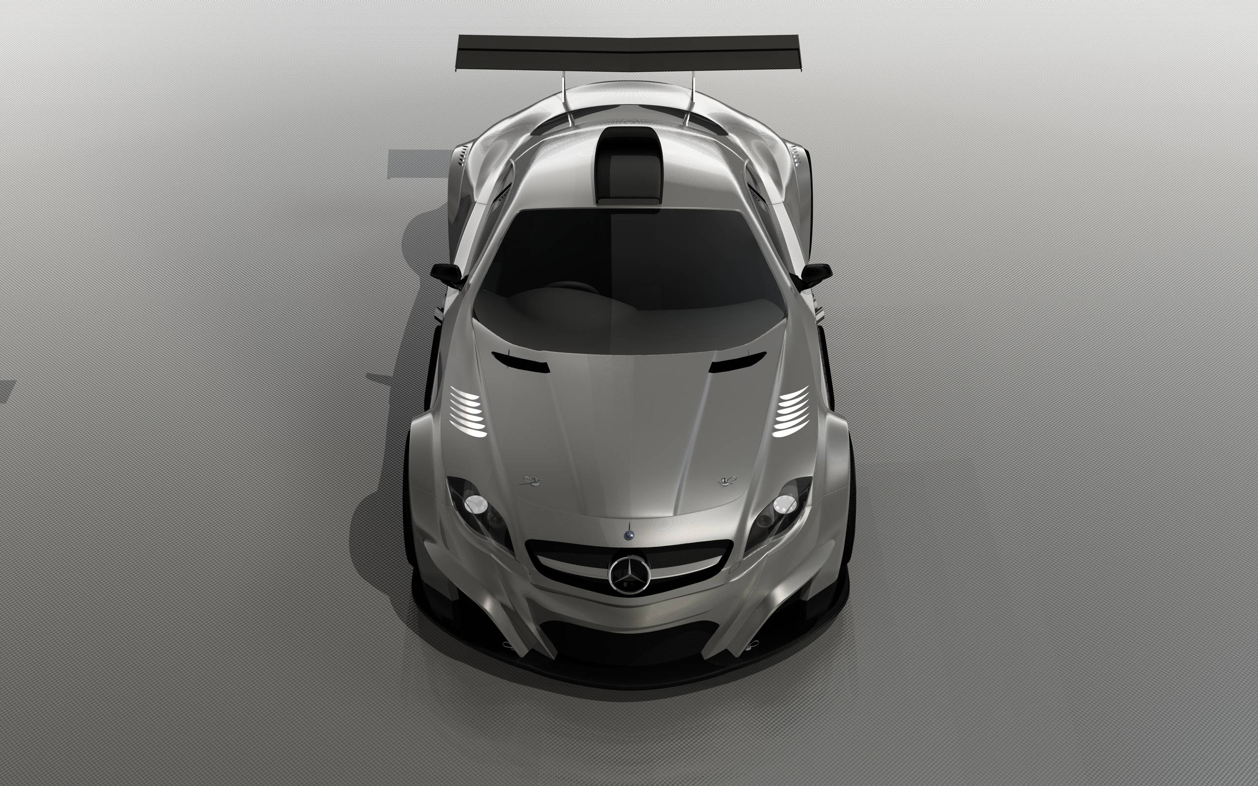 mercedes iPhone 桌布 壁紙 — 從上方俯瞰一輛時尚的銀色 Mercedes-AMG GT 賽車，背景為簡約灰色工作室。