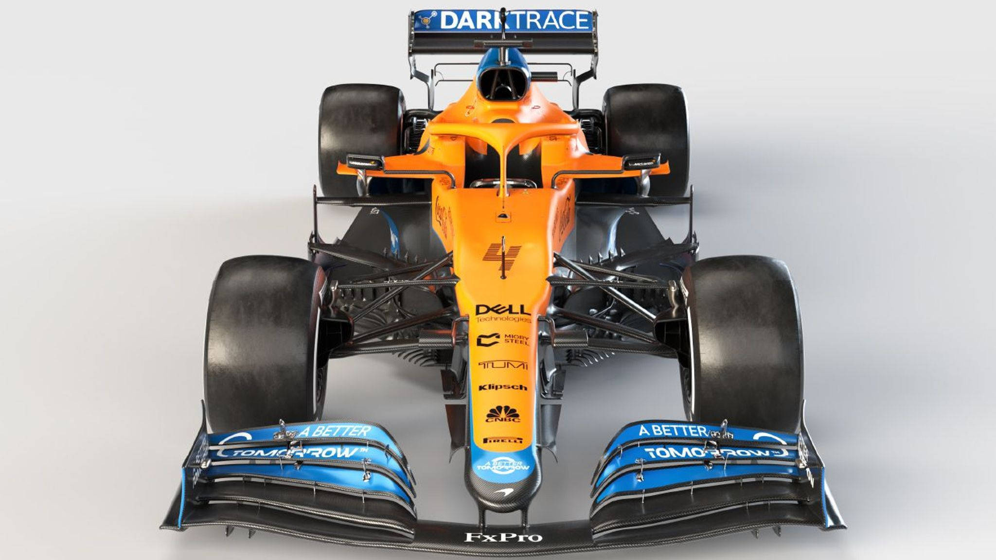 運動 桌布 壁紙 — 從上方俯瞰一輛橙色和藍色的 Formula 1 賽車，帶有贊助商標誌，背景為純白色。