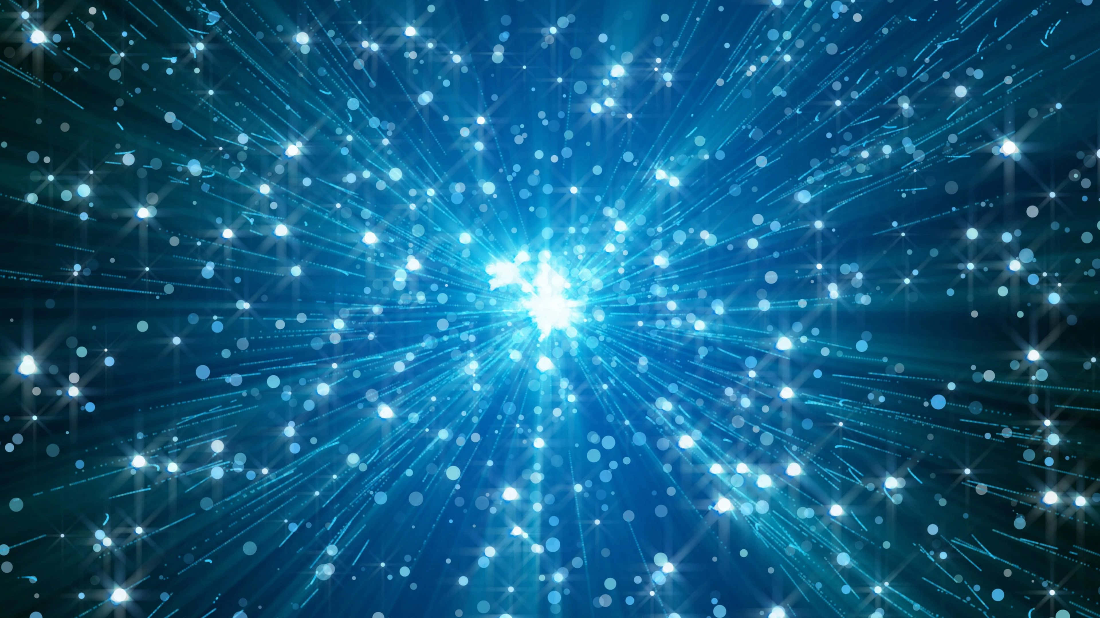 藍色 桌布 壁紙 — 從中央光源散發出閃爍粒子與星光的藍色宇宙爆發。