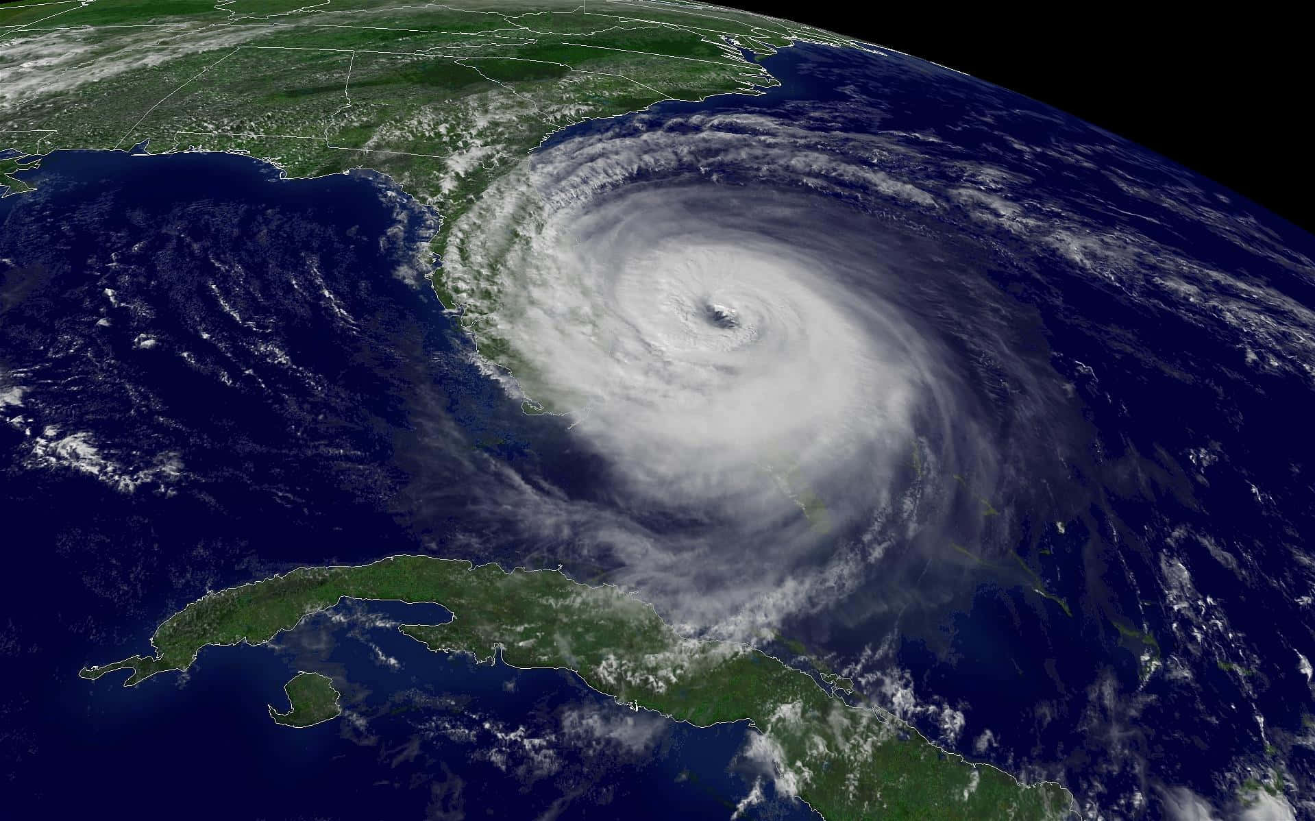 Hurricane 桌布 壁紙 — 從太空看到一個巨大的颶風在加勒比海上空旋轉，帶有明顯的風眼和螺旋狀雲層。