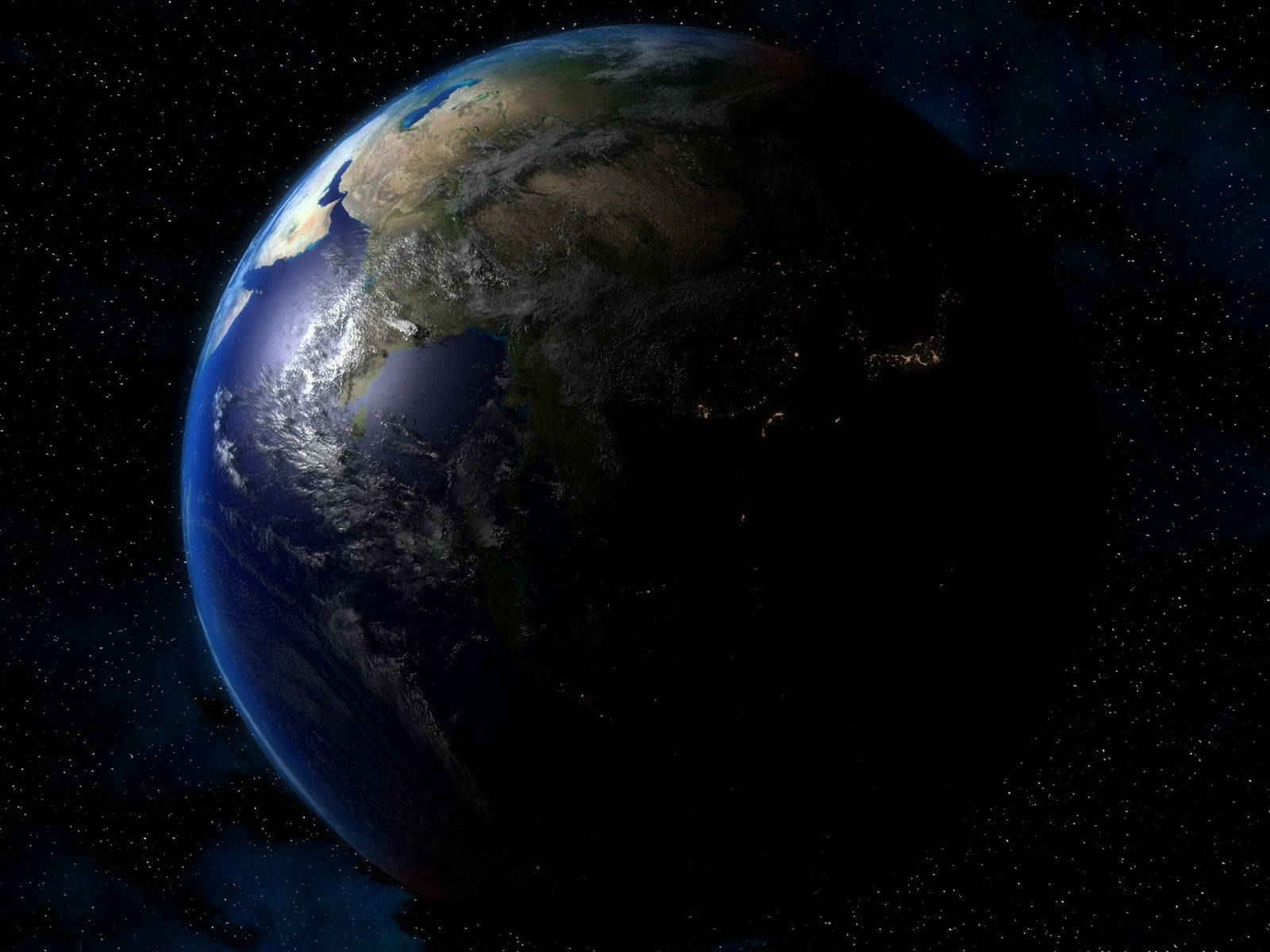 地球 桌布 壁紙 — 從太空看到的地球，一半被太陽照亮，一半在黑暗中顯示城市燈光。