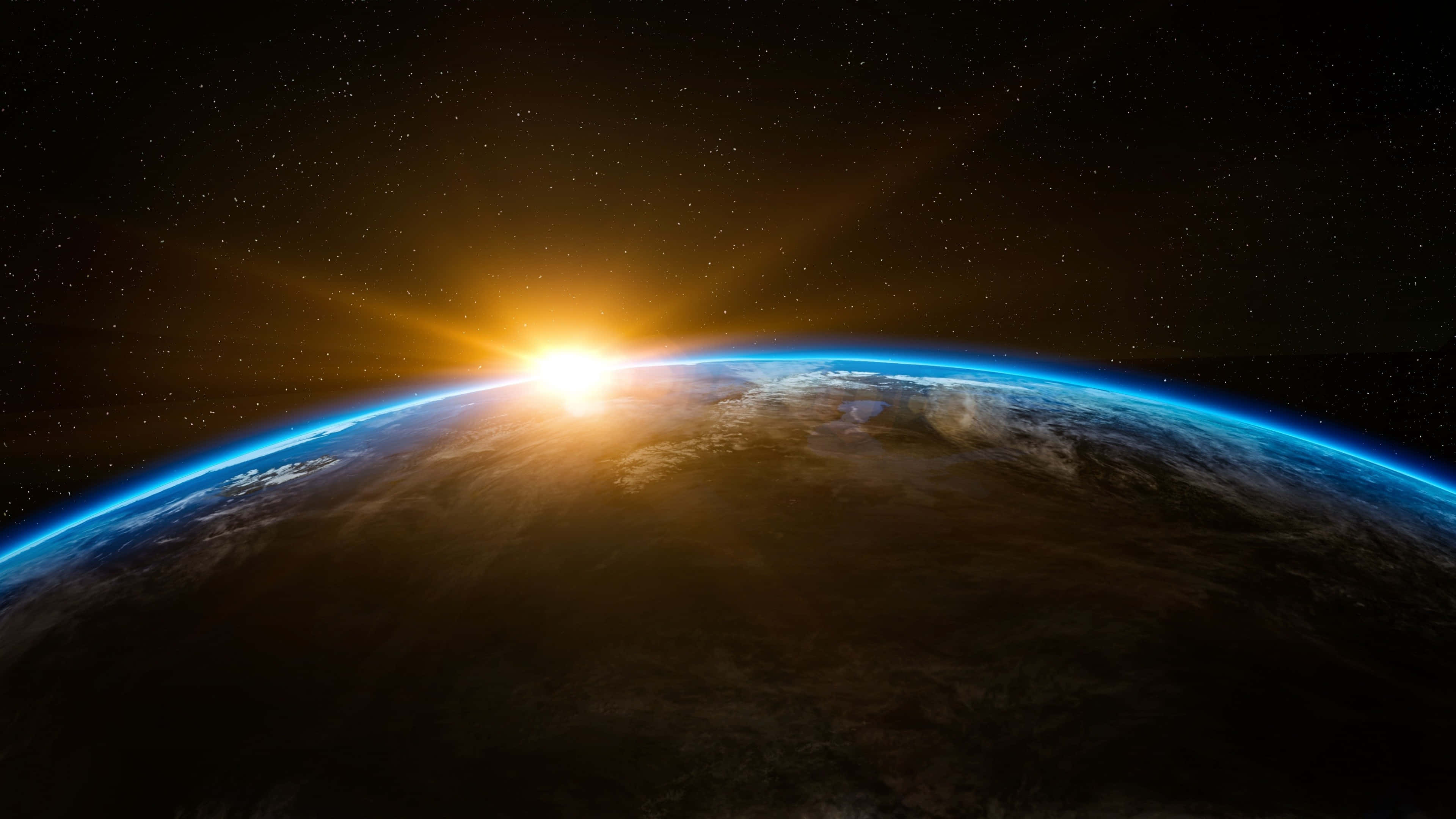 4K 太空 桌布 壁紙 — 從太空看地球上的日出，顯示藍色大氣輝光和星空黑色天空。